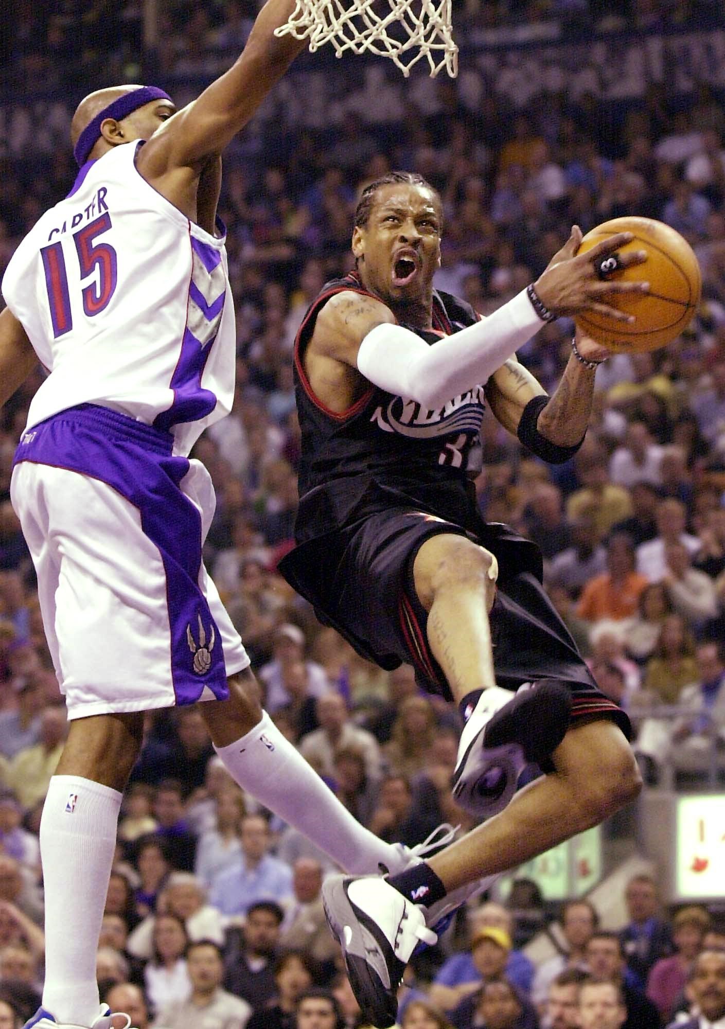 Philadelphia 76ers' Allen Iverson (R) drives past Toronto Raptors' Vince Carter during first half action of game three of the Eastern Conference semifinal NBA playoffs in Toronto, Canada, 11 May, 2001.