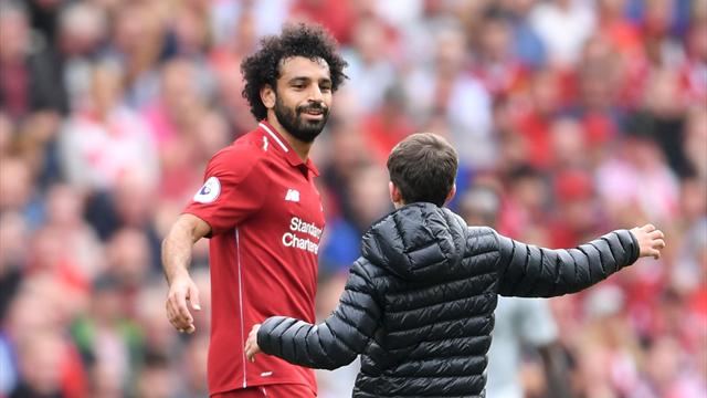 PHOTOS: Salah hugs young fan on pitch during match