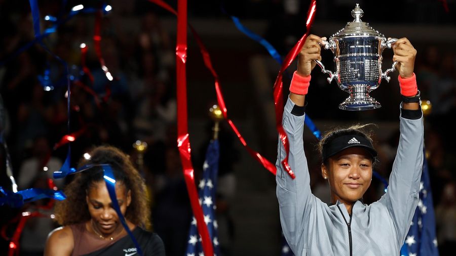 Naomi Osaka of Japan poses with the championship trophy after winning the Women's Singles finals match against Serena Williams of the United States on Day Thirteen of the 2018 US Open at the USTA Billie Jean King National Tennis Center