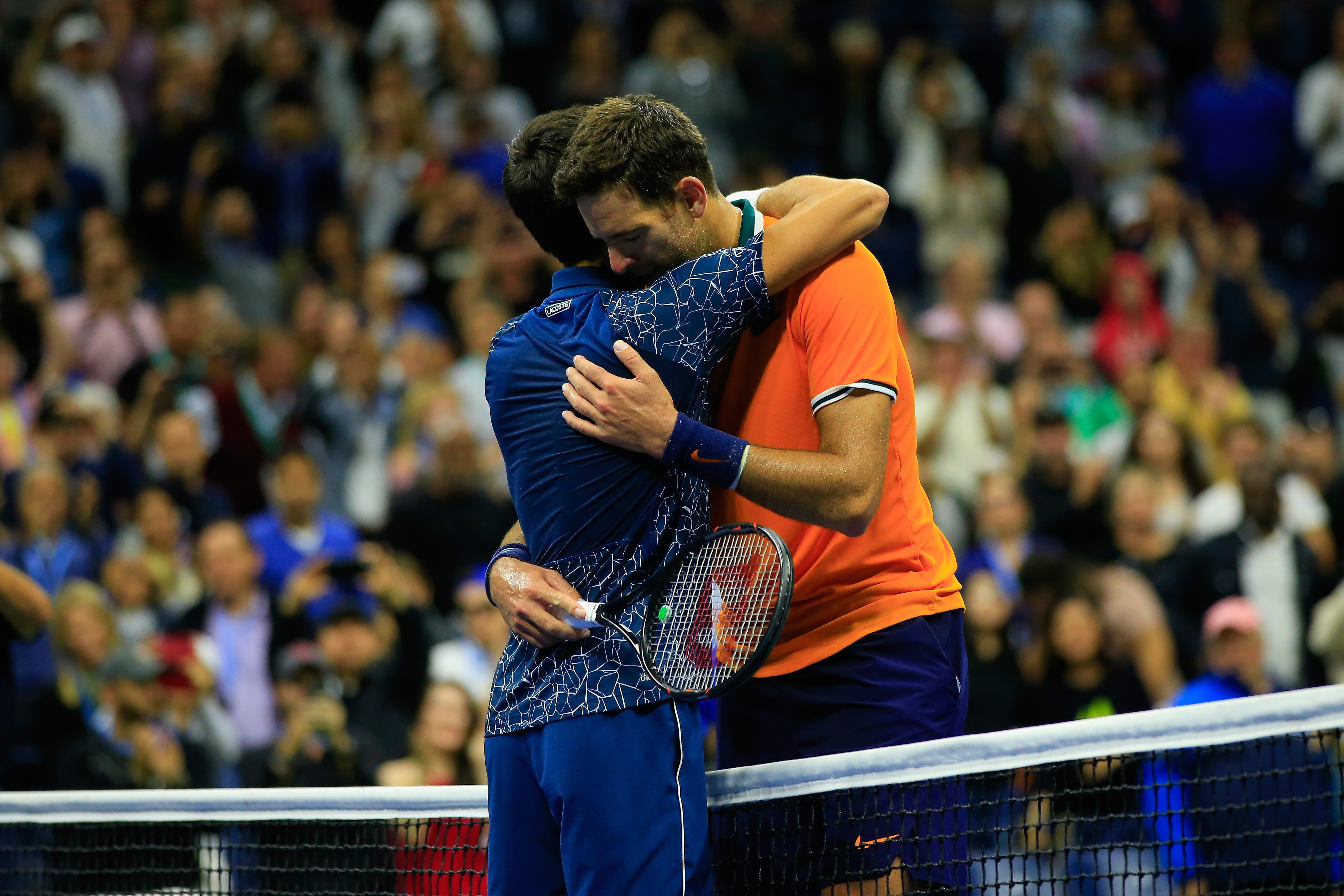 Novak Djokovic of Serbia is congratulated on his win by Juan Martin del Potro