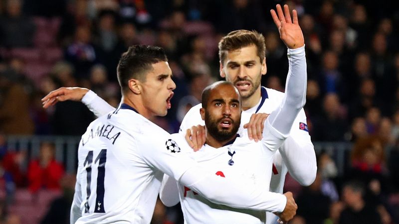 Lucas Moura of Tottenham Hotspur (C) celebrates after scoring his team's first goal with Erik Lamela and Fernando Llorente during the UEFA Champions League Group B match between FC Barcelona and Tottenham Hotspur at Camp Nou on December 11, 2018 in Barcel