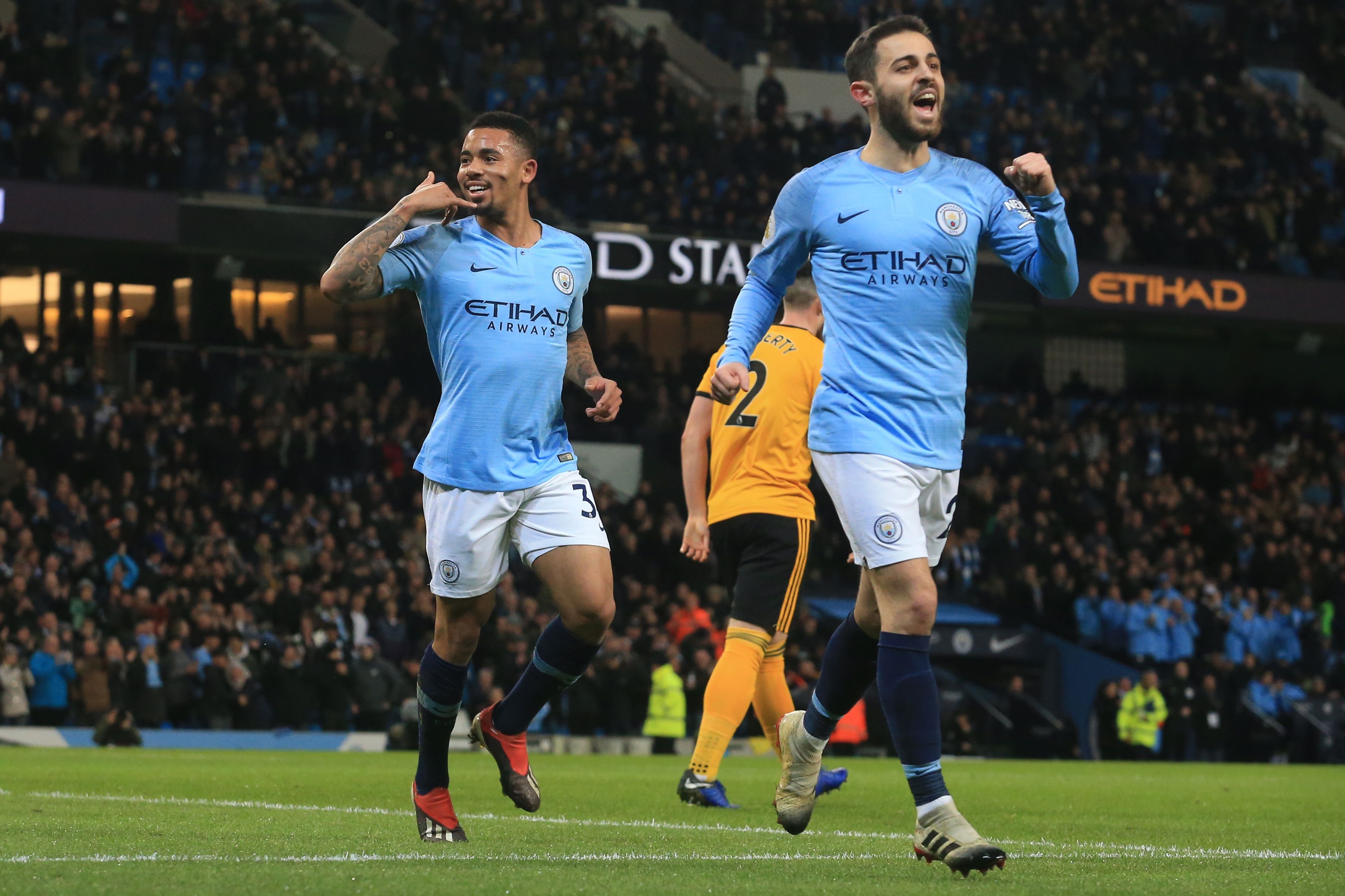 Manchester City's Brazilian striker Gabriel Jesus (L) celebrates with Manchester City's Portuguese midfielder Bernardo Silva (R) after scoring the opening goal of the English Premier League football match between Manchester City and Wolverhampton Wanderer