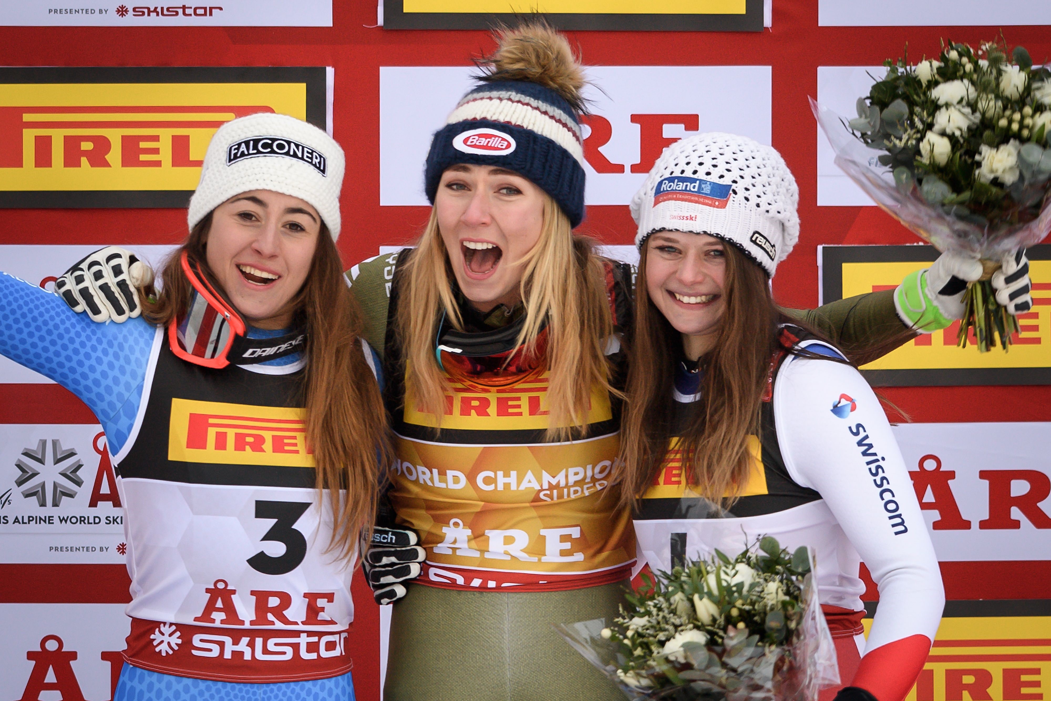 Silver medallist Italys Sofia Goggia, gold medallist US Mikaela Shiffrin and bronze medallist Switzerland's Corinne Suter celebrate during the flower ceremony of the women's Super G event of the 2019 FIS Alpine Ski World Championships at the National Aren