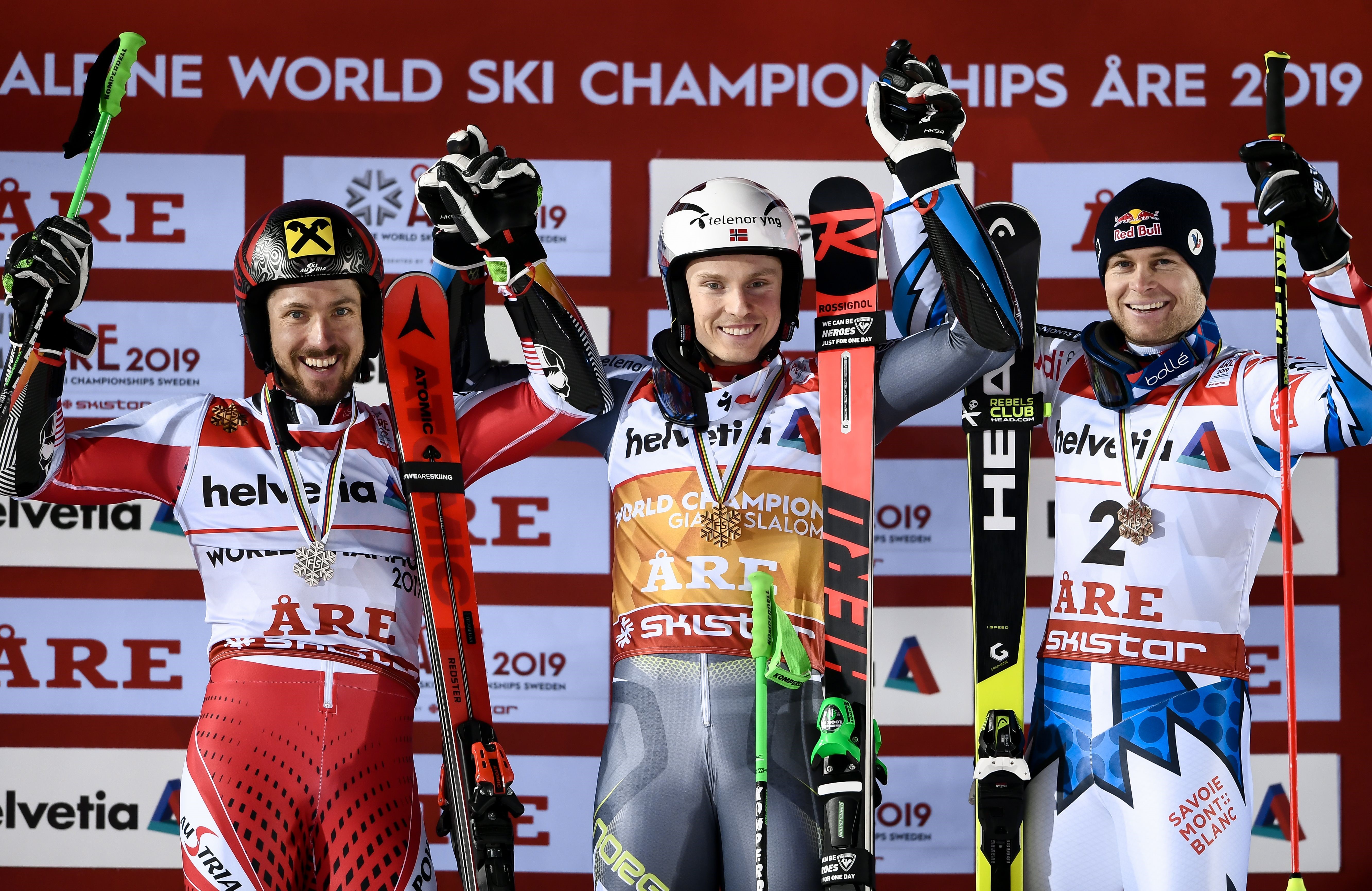 Second placed Austria's Marcel Hirscher, winner Norway's Henrik Kristoffersen, and third placed France's Alexis Pinturault celebrate after the second run of the men's Giant slalom event at the 2019 FIS Alpine Ski World Championships at the National Arena