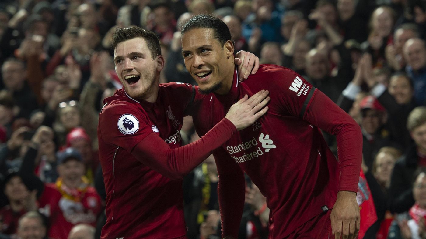 Virgil van Dijk of Liverpool celebrates with team-mate Andrew Robertson