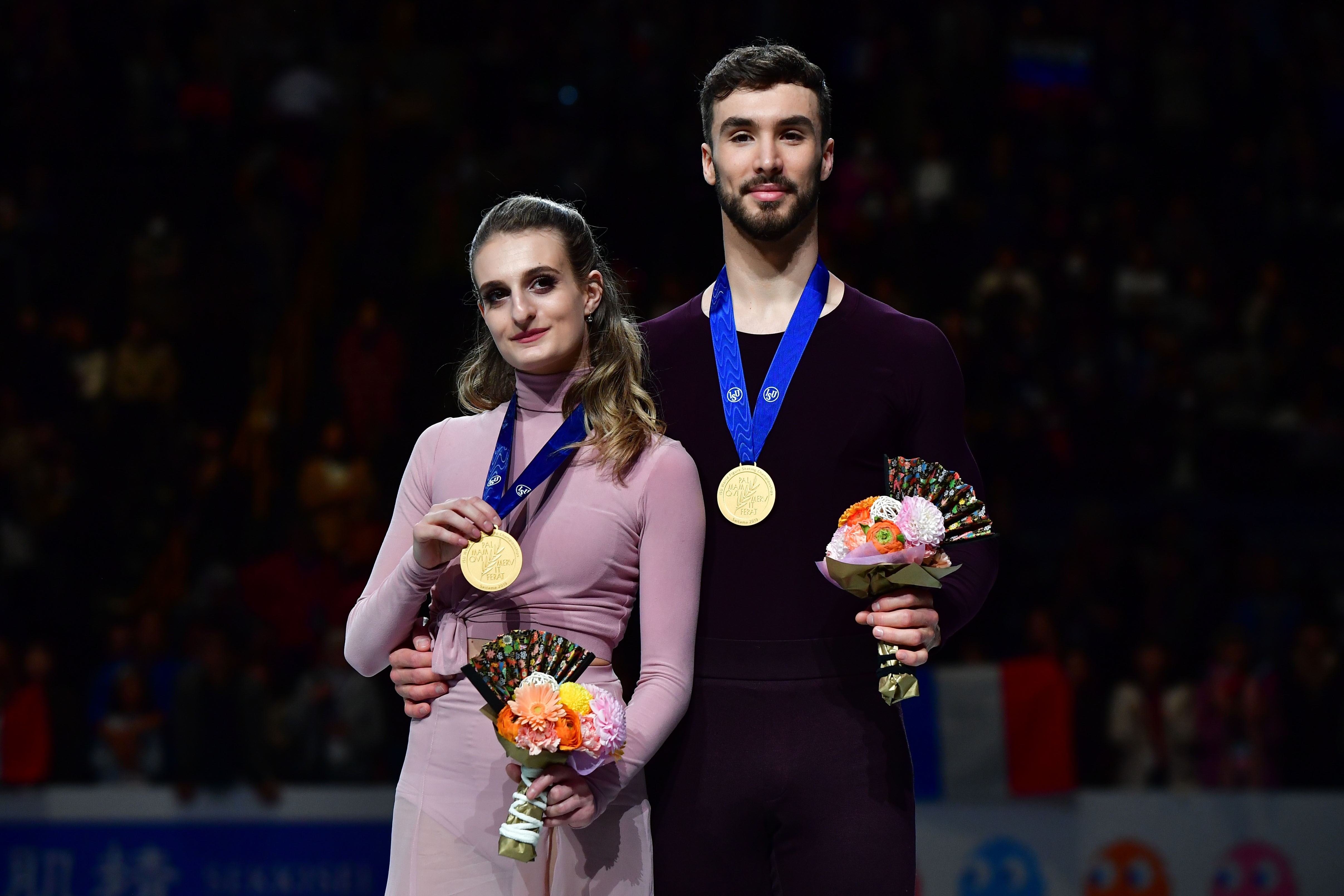 ISU World Figure Skating Championships Ice Dance winner Gabriella Papadakis and Guillaume Cizeron of France pose with their national flag during the victory ceremony in Saitama, northern suburb of Tokyo on March 23, 2019