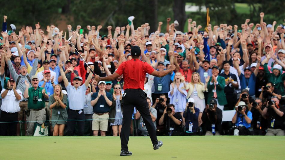 Tiger Woods of the United States celebrates after sinking his putt on the 18th green to win during the final round of the Masters at Augusta National Golf Club on April 14, 2019 in Augusta, Georgia