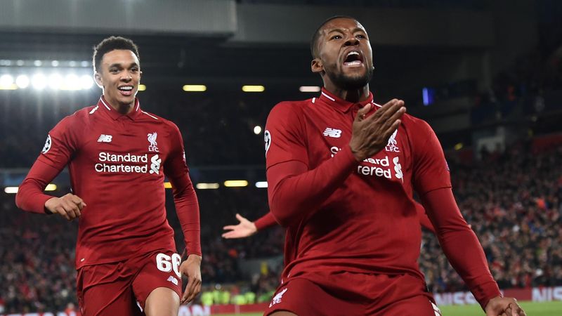 Liverpool's Dutch midfielder Georginio Wijnaldum (C) celebrates after scoring their third goal