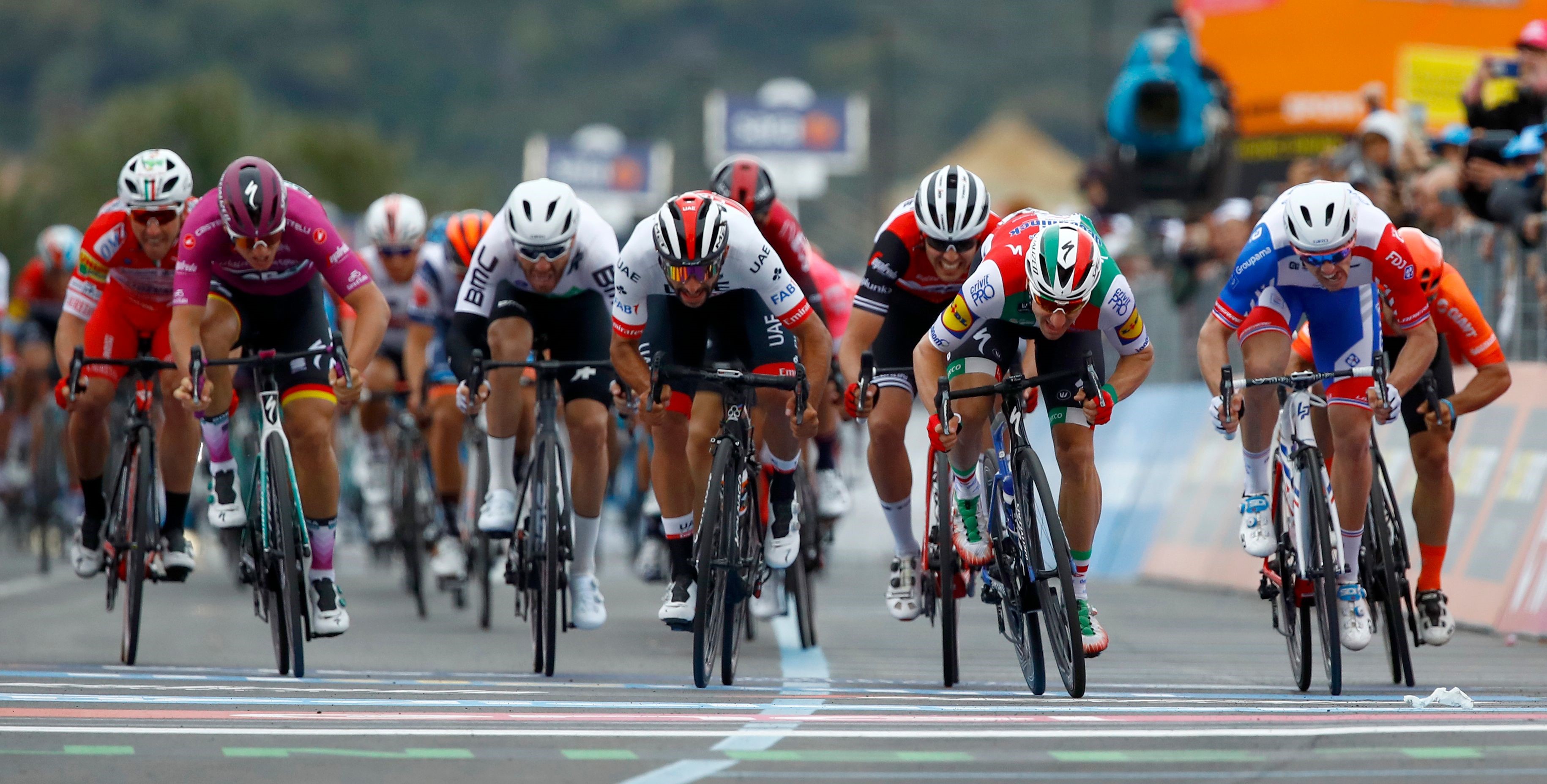 eam Deceuninck rider Italy's Elia Viviani (2nd R) during final sprint in the stage three of the 102nd Giro d'Italia - Tour of Italy - cycle race, 220kms from Vinci to Orbetello on May 13, 2019