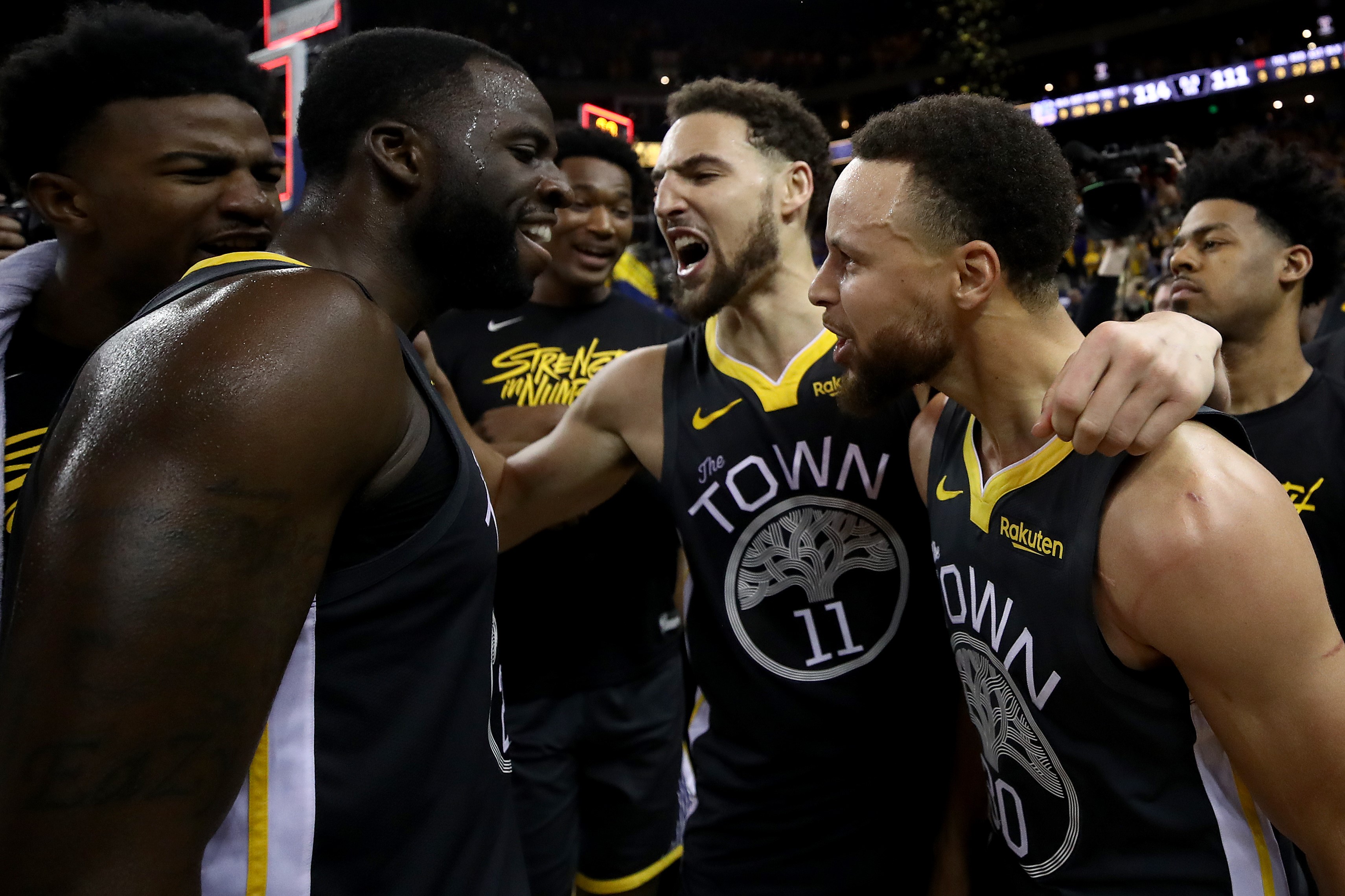 Stephen Curry #30, Klay Thompson #11 and Draymond Green #23 of the Golden State Warriors celebrate after defeating the Portland Trail Blazers 114-111 in game two of the NBA Western Conference Finals at ORACLE Arena on May 16, 2019 in Oakland