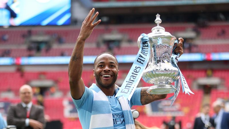 Raheem Sterling of Manchester City celebrates with the trophy after victory in the FA Cup Final match between Manchester City and Watford at Wembley Stadium on May 18, 2019 in London, England.