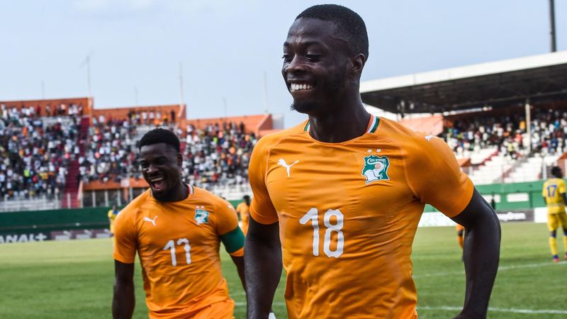 Ivory Coast's Serge Aurier (L) and Nicolas Pepe (R) celebrate a goal during the 2019 African Cup of Nations Group H qualification football match between Ivory Coast and Rwanda on March 23, 2019 at the Felix Houphouet-Boigny stadium in Abidjan.