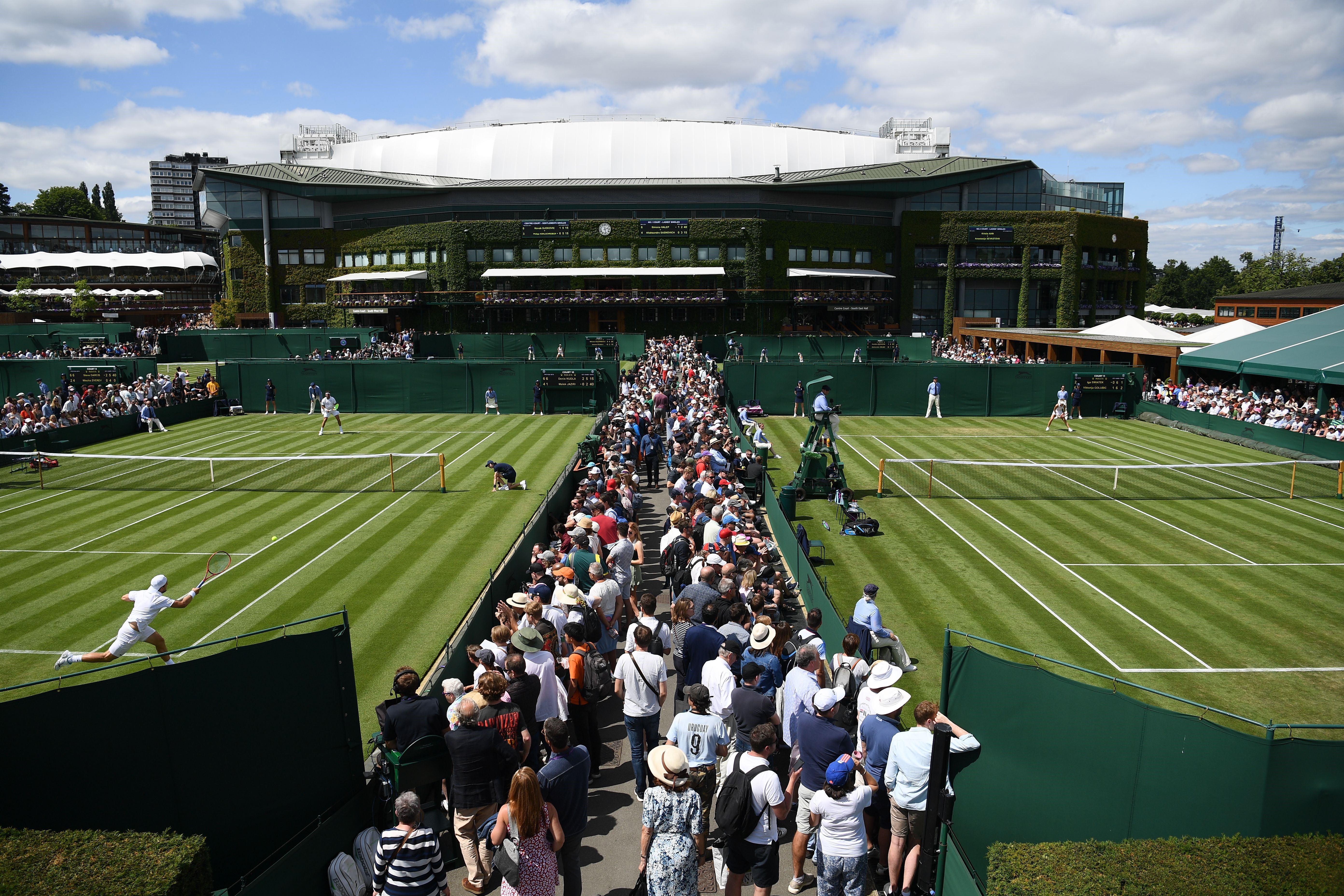 Play goes on on the outer courts at The All England Tennis Club in Wimbledon, southwest London, on July 1, 2019, on the first day of the 2019 Wimbledon Championships tennis tournament. (Photo by Daniel LEAL-OLIVAS / AFP)