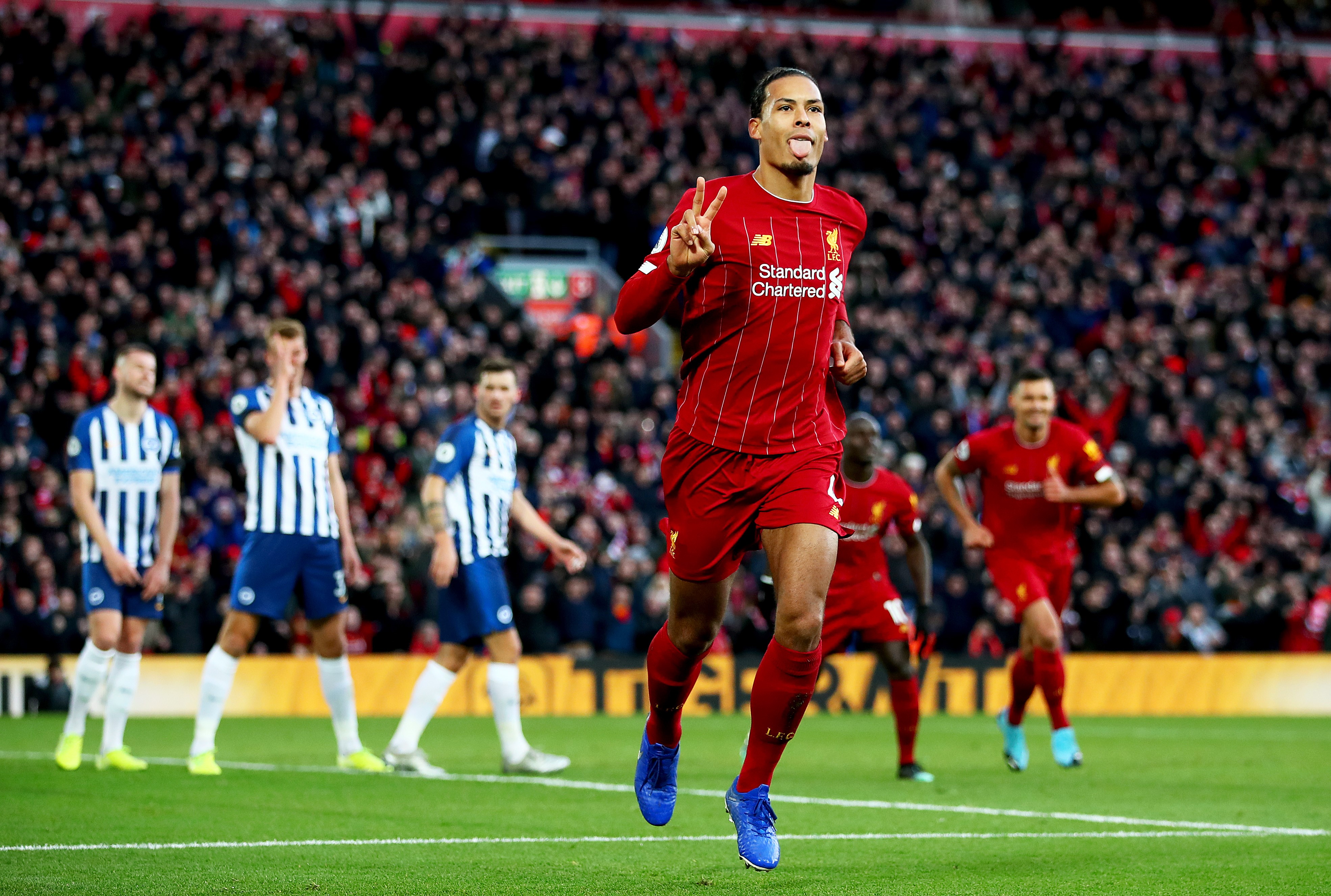 Virgil van Dijk of Liverpool celebrates scoring his teams second goal during the Premier League match between Liverpool FC and Brighton & Hove Albion at Anfield