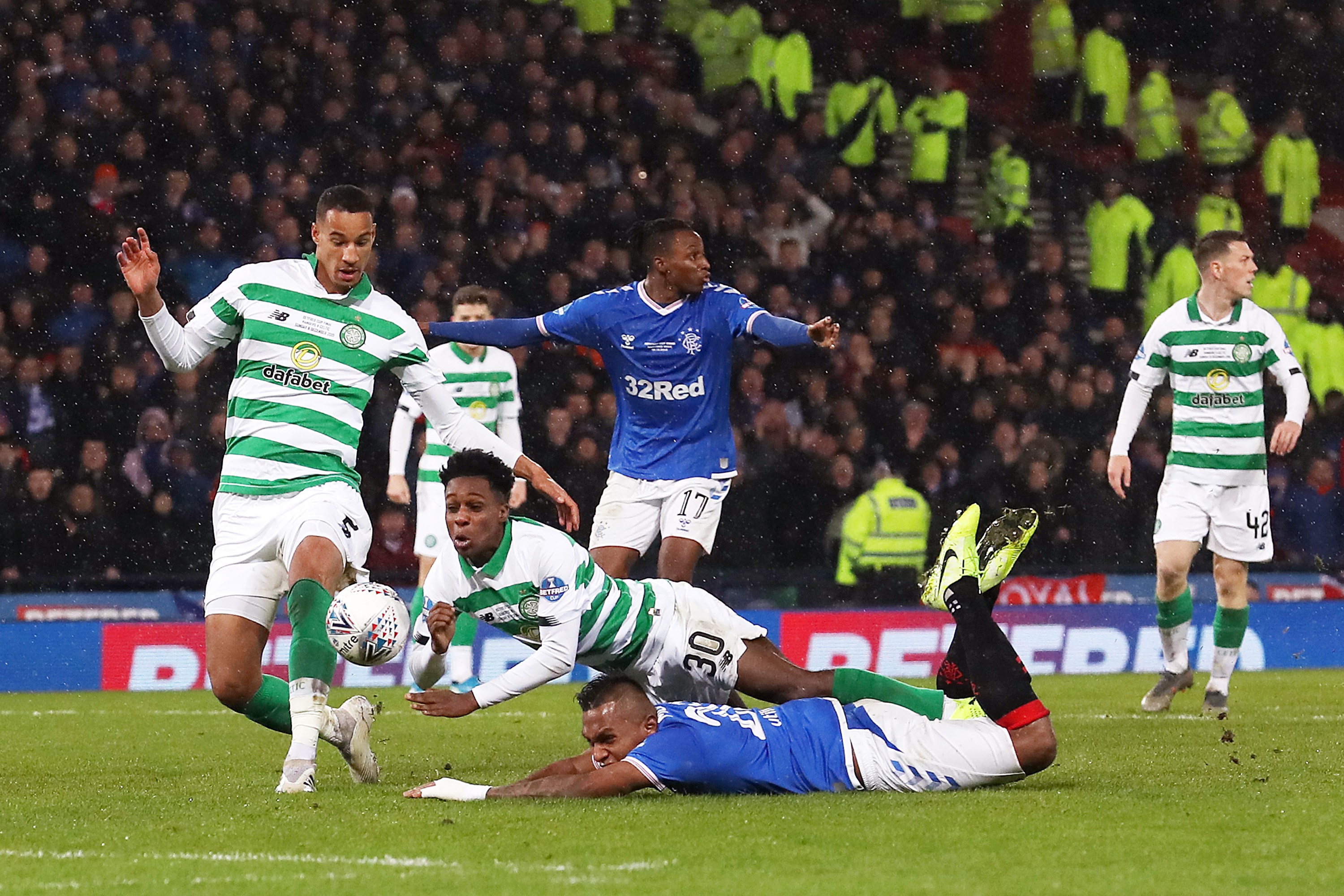 Jeremie Frimpong of Celtic tackles Alfredo Morelos of Rangers FC which leads to a penalty and a red card for Jeremie Frimpong of Celtic during the Betfred Cup Final between Rangers FC and Celtic FC at Hampden Park on December 08, 2019 in Glasgow, Scotland