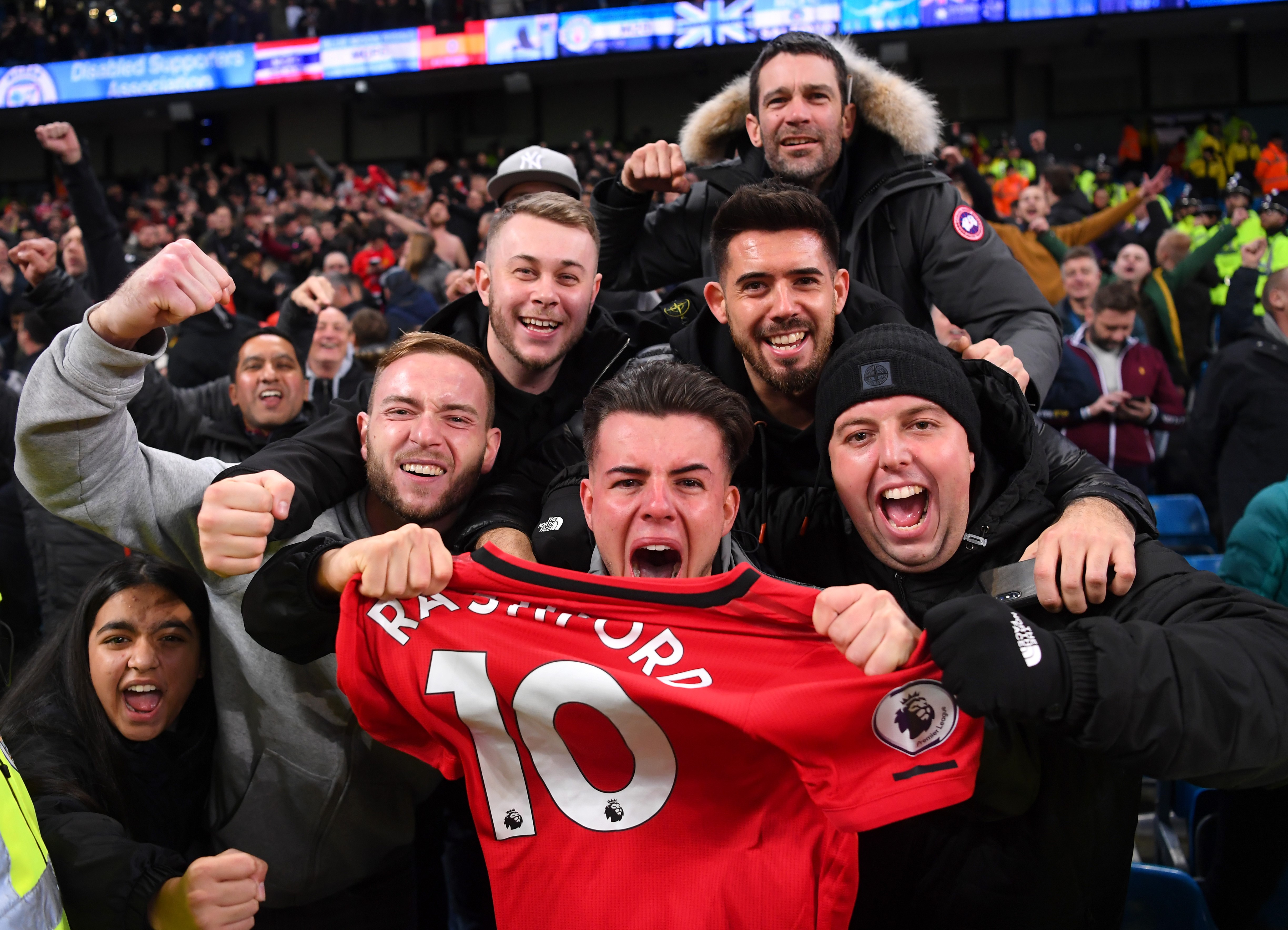 Manchester United fans celebrate with Marcus Rashford of Manchester United's shirt following the Premier League match between Manchester City and Manchester United at Etihad Stadium on December 07, 2019 in Manchester, United Kingdom.