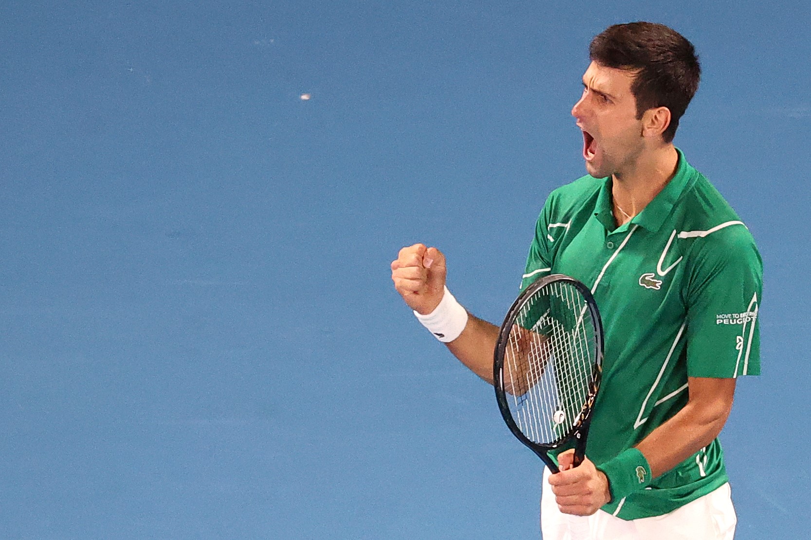 Serbia's Novak Djokovic reacts after a point against Austria's Dominic Thiem during their men's singles final match on day fourteen of the Australian Open tennis tournament in Melbourne on February 2, 2020