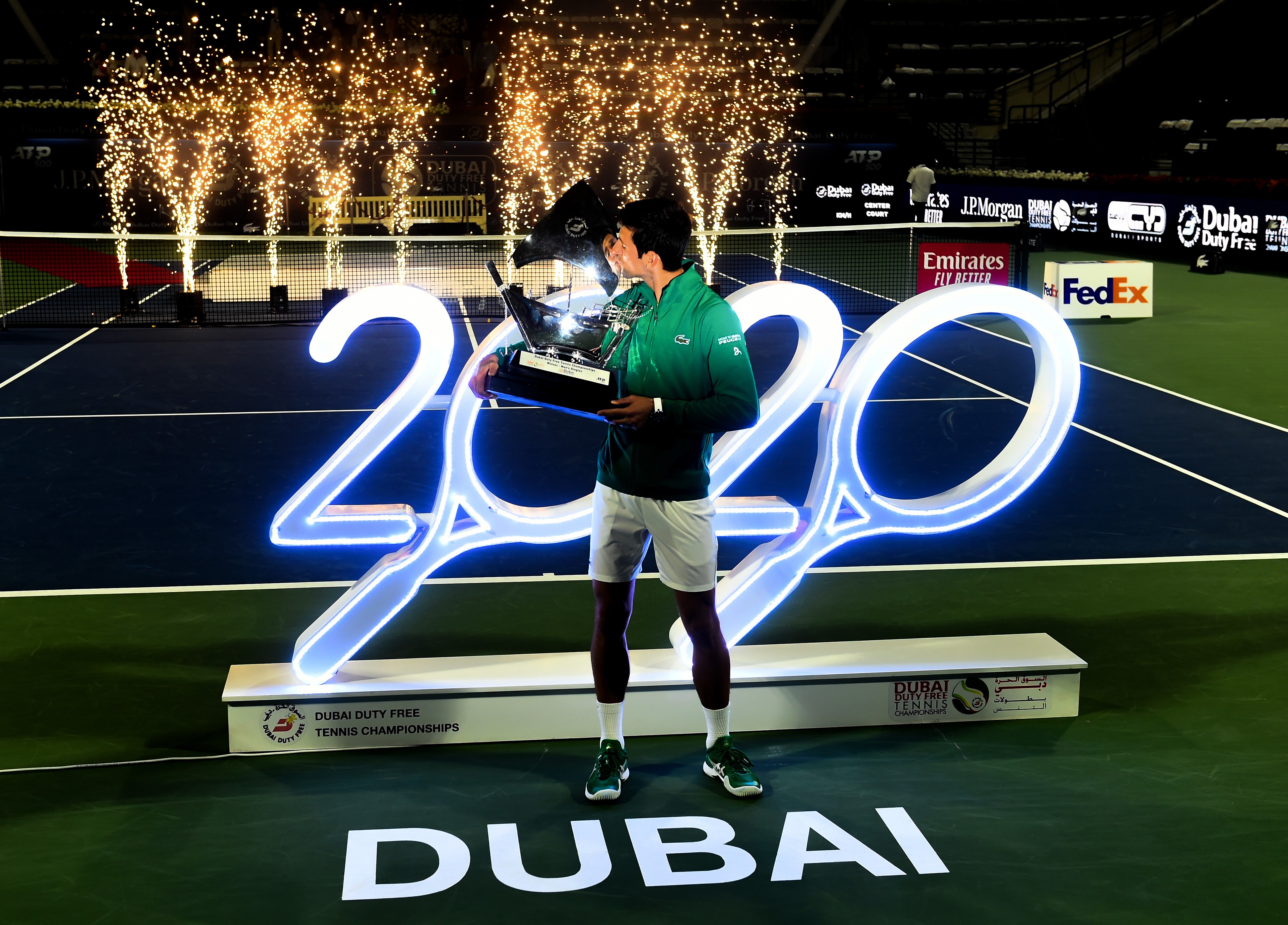 Novak Djokovic of Serbia celebrates with the trophy after winning his men's final match against Stefanos Tsitsipas of Greece on Day 13 of the Dubai Duty Free Tennis at Dubai Duty Free Tennis Stadium on February 29, 2020 in Dubai, United Arab Emirates