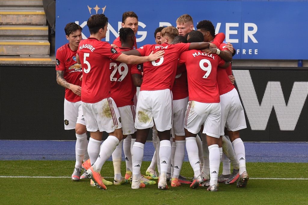 Manchester United's Portuguese midfielder Bruno Fernandes celebrates with team-mates after scoring the opening goal during the English Premier League football match between Leicester City and Manchester United at King Power Stadium in Leicester, central E