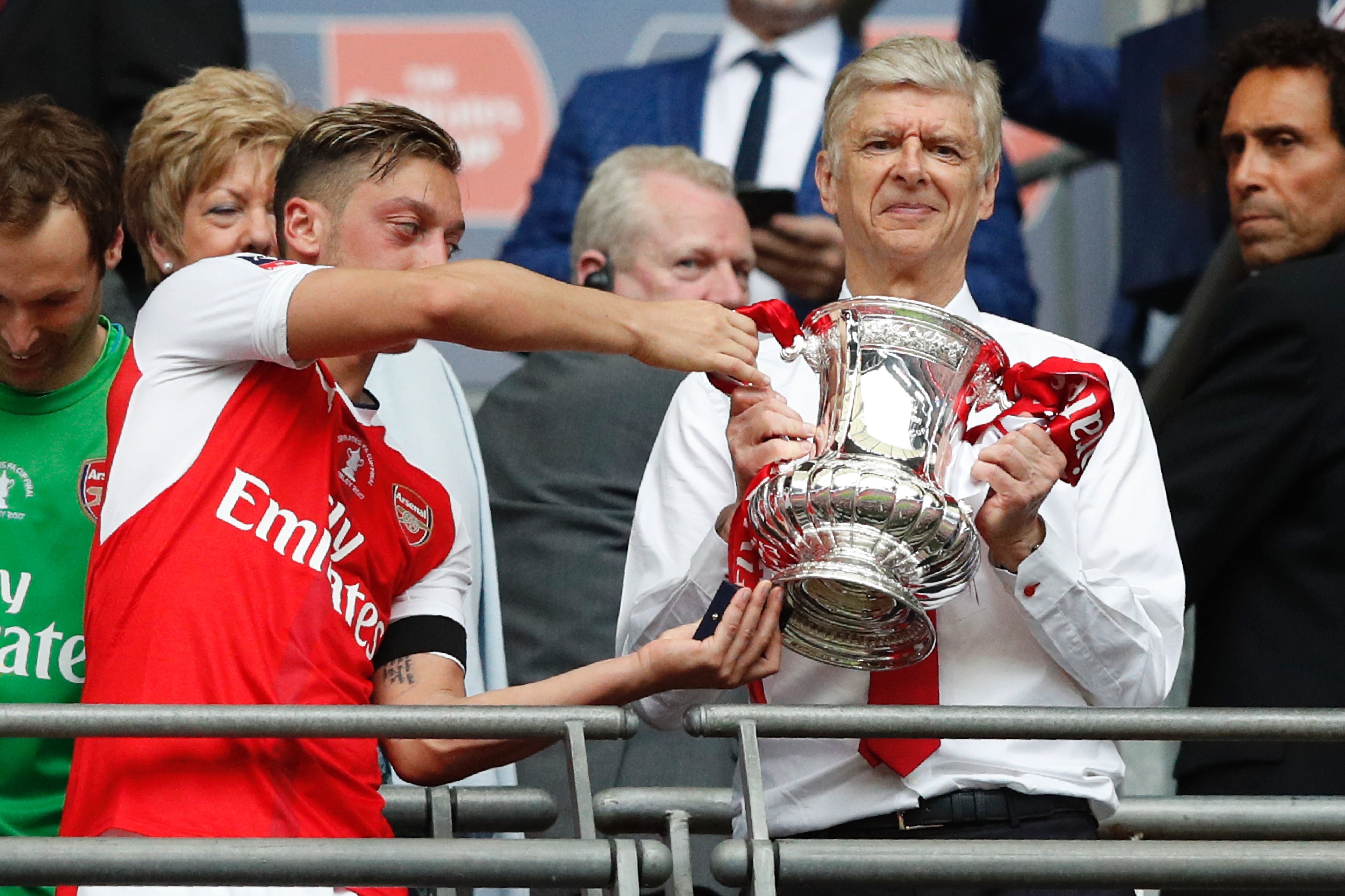 Mesut Ozil and Arsene Wenger with the FA Cup after the 2017 final win over Chelsea at Wembley