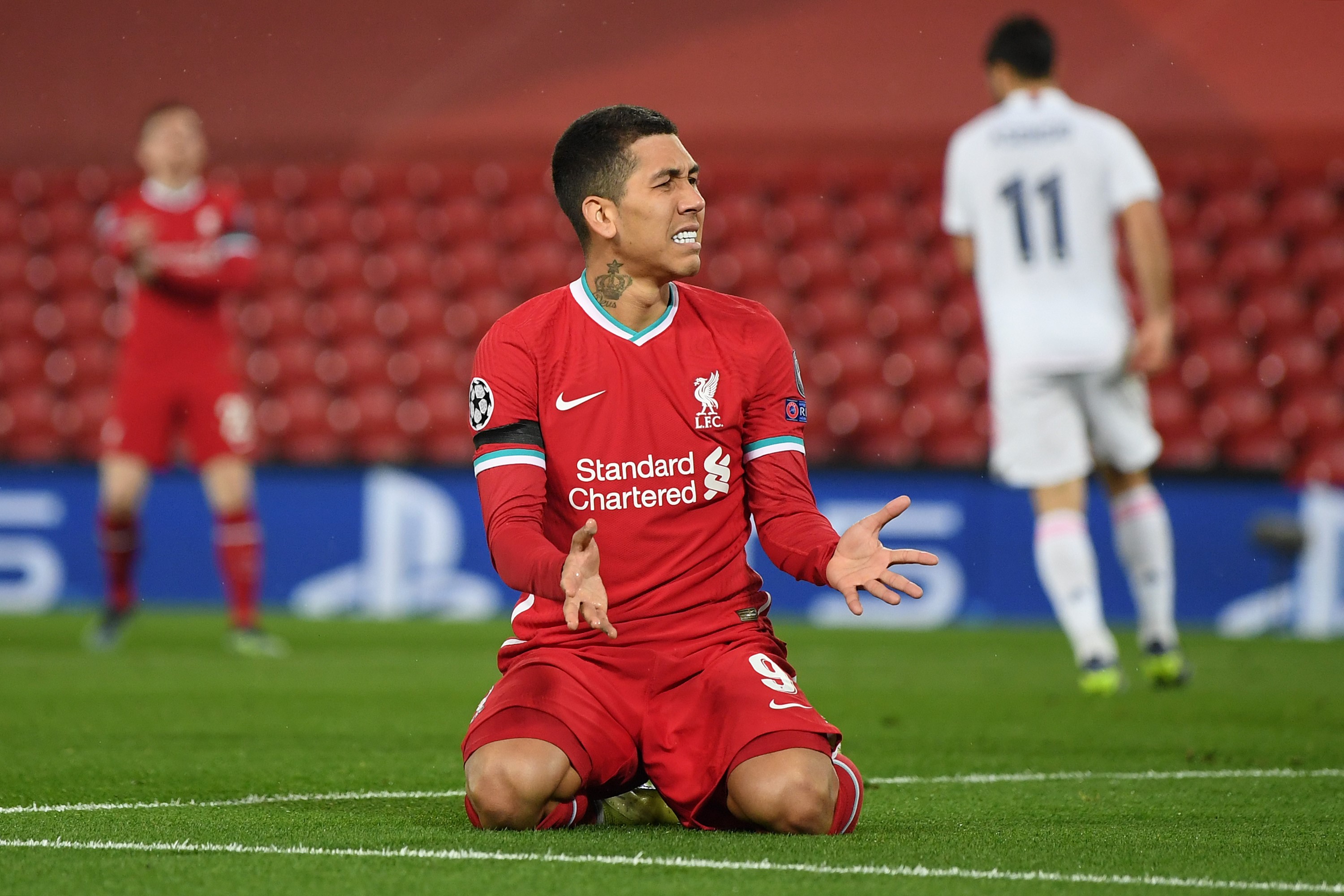 : Roberto Firmino of Liverpool reacts after missing a chance during the UEFA Champions League Quarter Final Second Leg match between Liverpool FC and Real Madrid at Anfield on April 14, 2021 in Liverpool, England.