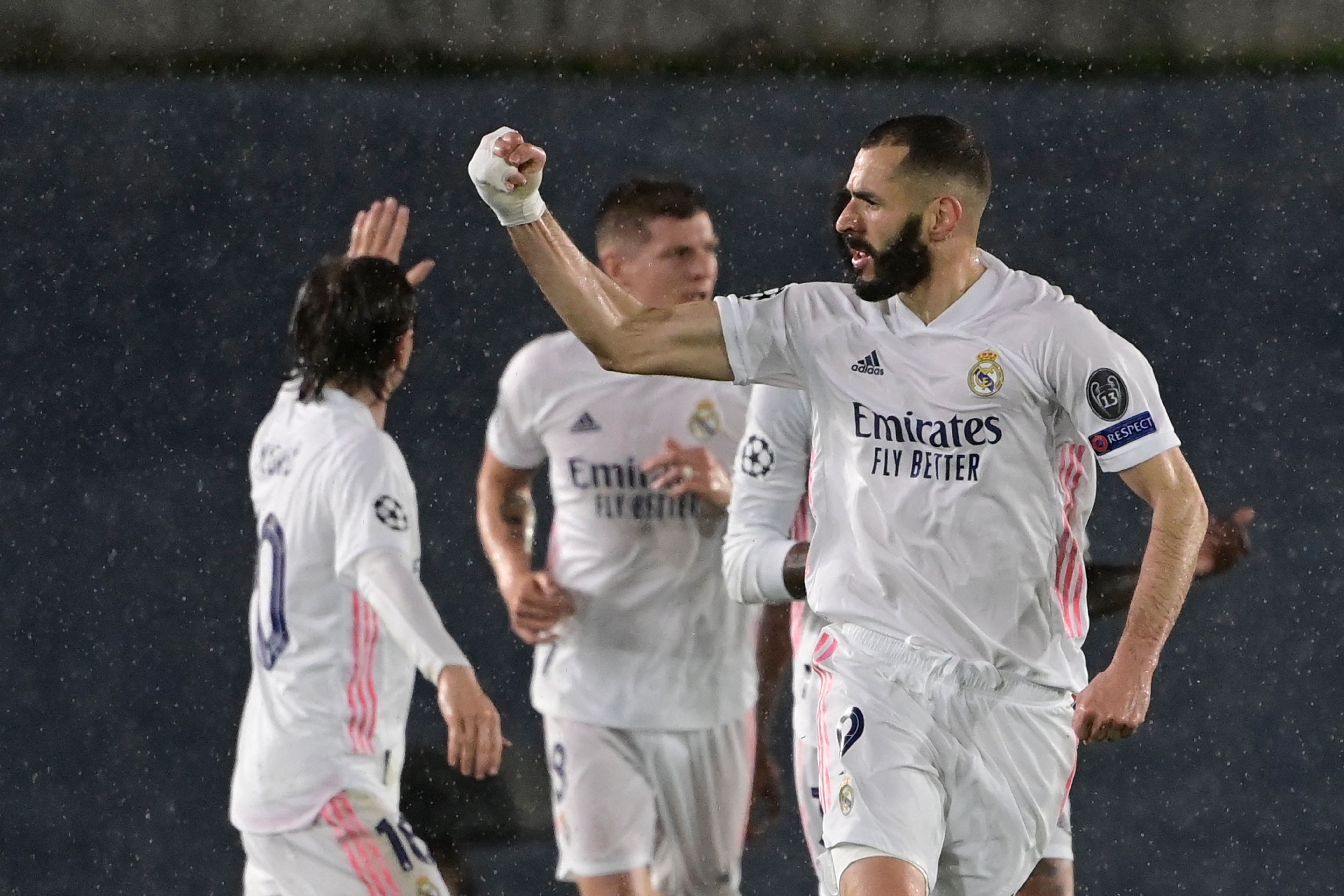 Real Madrid's French forward Karim Benzema (R) celebrates after scoring during the UEFA Champions League semi-final first leg football match between Real Madrid and Chelsea at the Alfredo di Stefano stadium in Valdebebas, on the outskirts of Madrid, on Ap