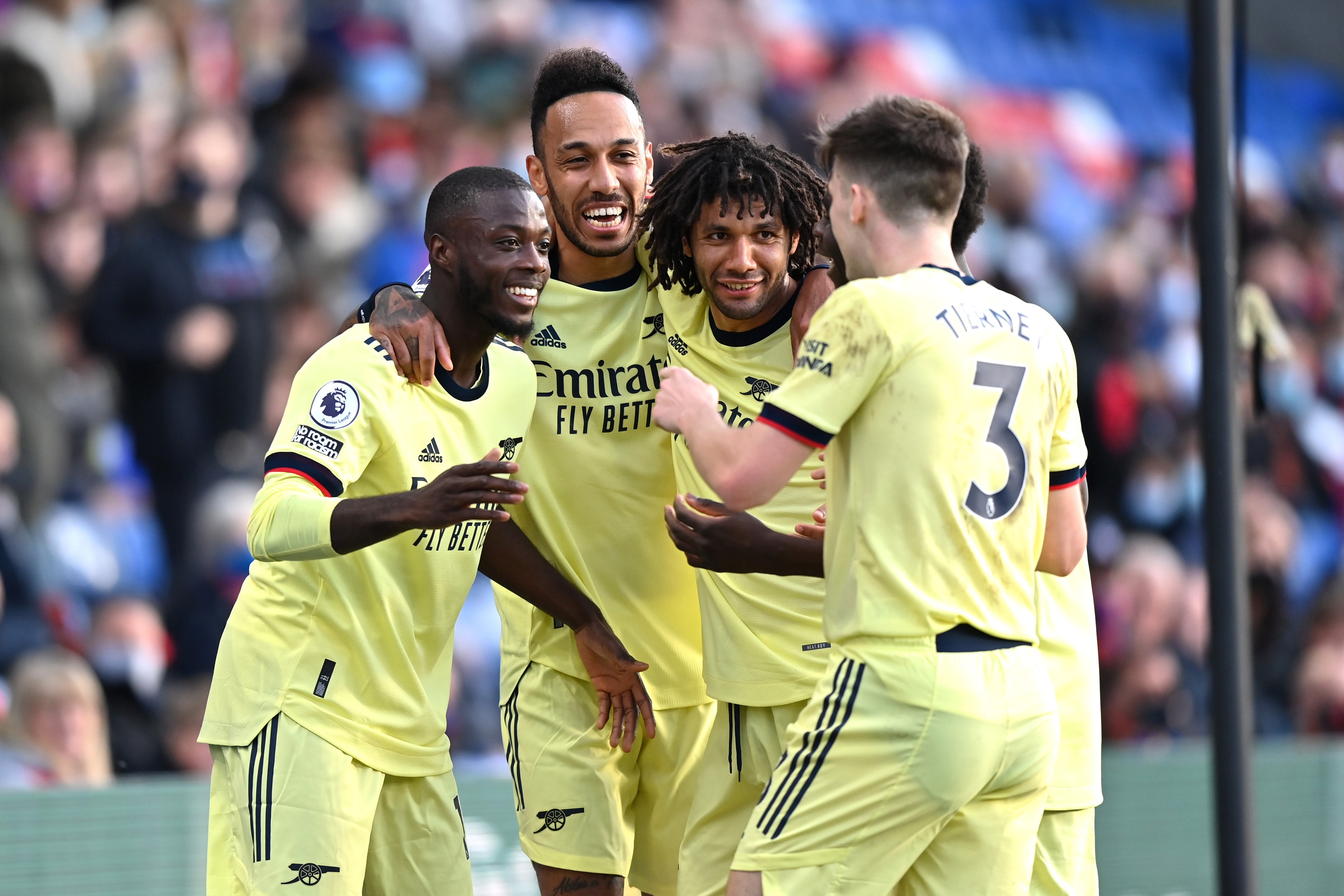 Nicolas Pepe of Arsenal celebrates with team mates Pierre Emerick Aubameyang, Mohamed Elneny and Kieran Tierney after scoring his team's first goal during the Premier League match between Crystal Palace and Arsenal at Selhurst Park