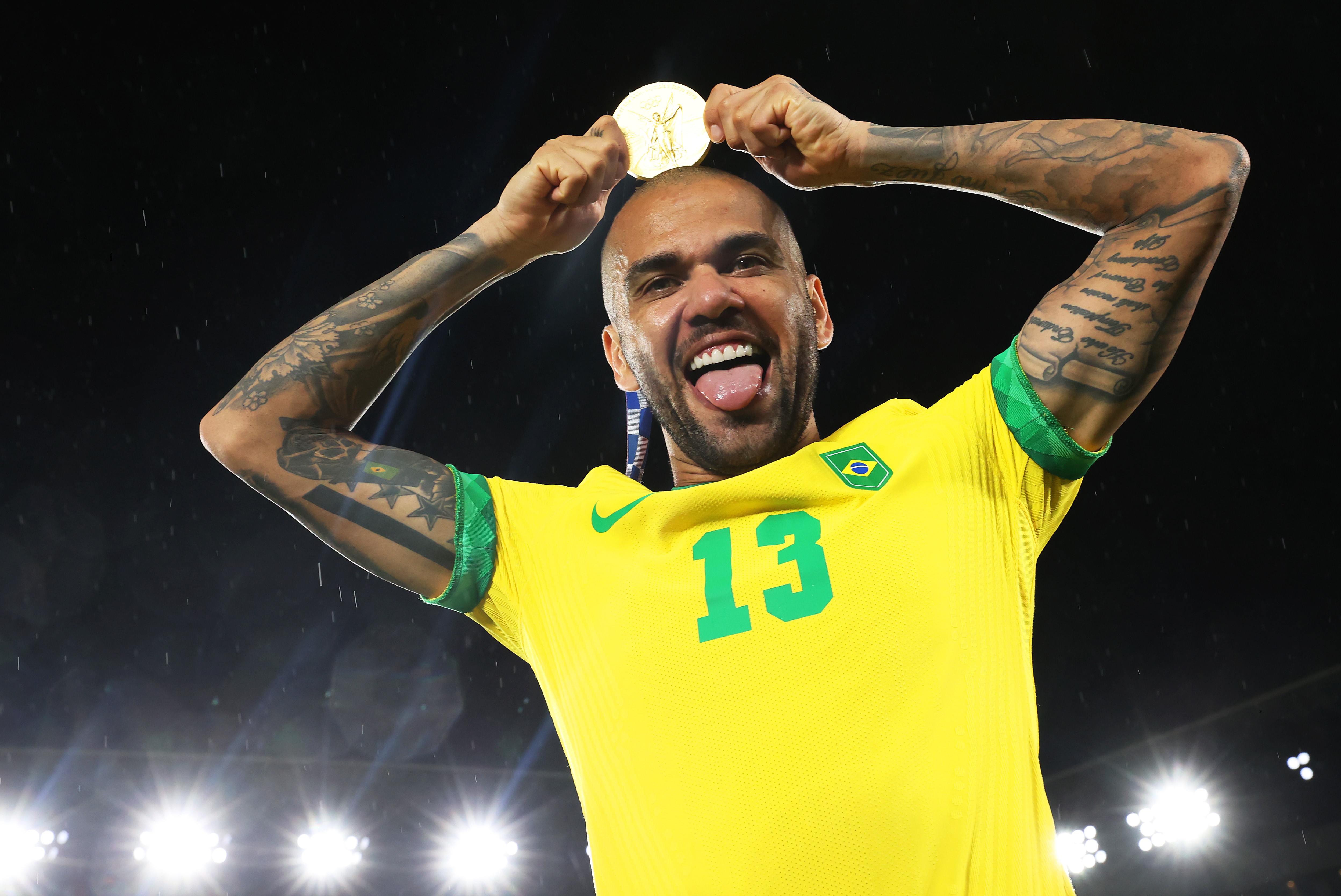 Gold medalist Dani Alves #13 of Team Brazil celebrates with their gold medal during the Men's Football Competition Medal Ceremony on day fifteen of the Tokyo 2020 Olympic Games at International Stadium Yokohama on August 07, 2021