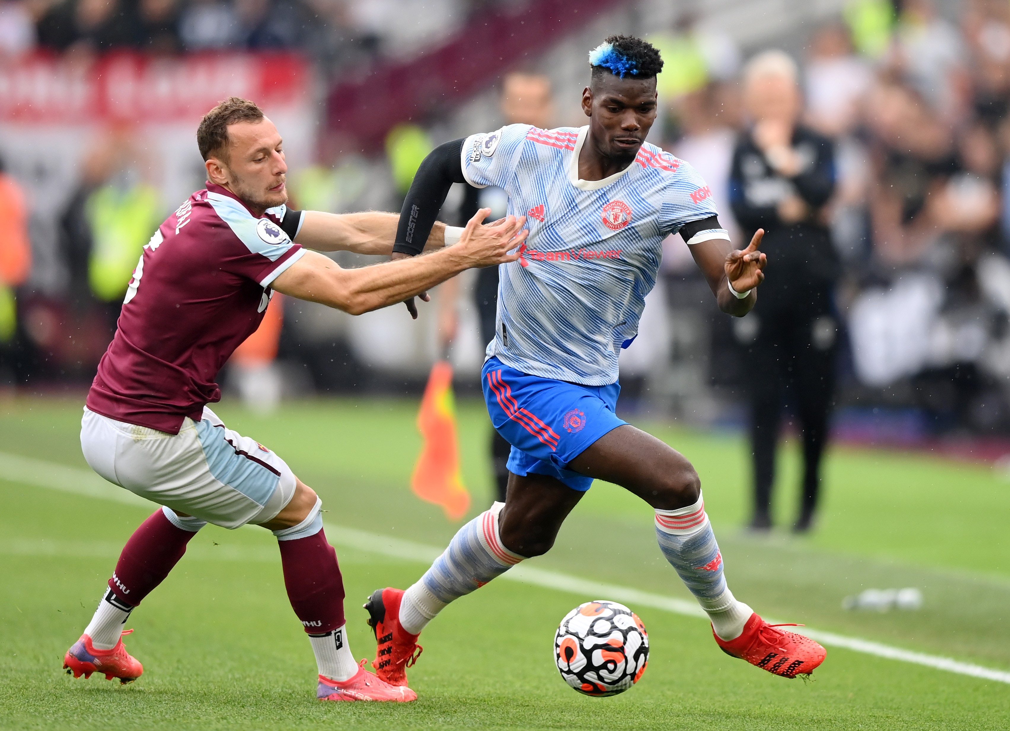 Paul Pogba of Manchester United battles for possession with Vladimir Coufal of West Ham United