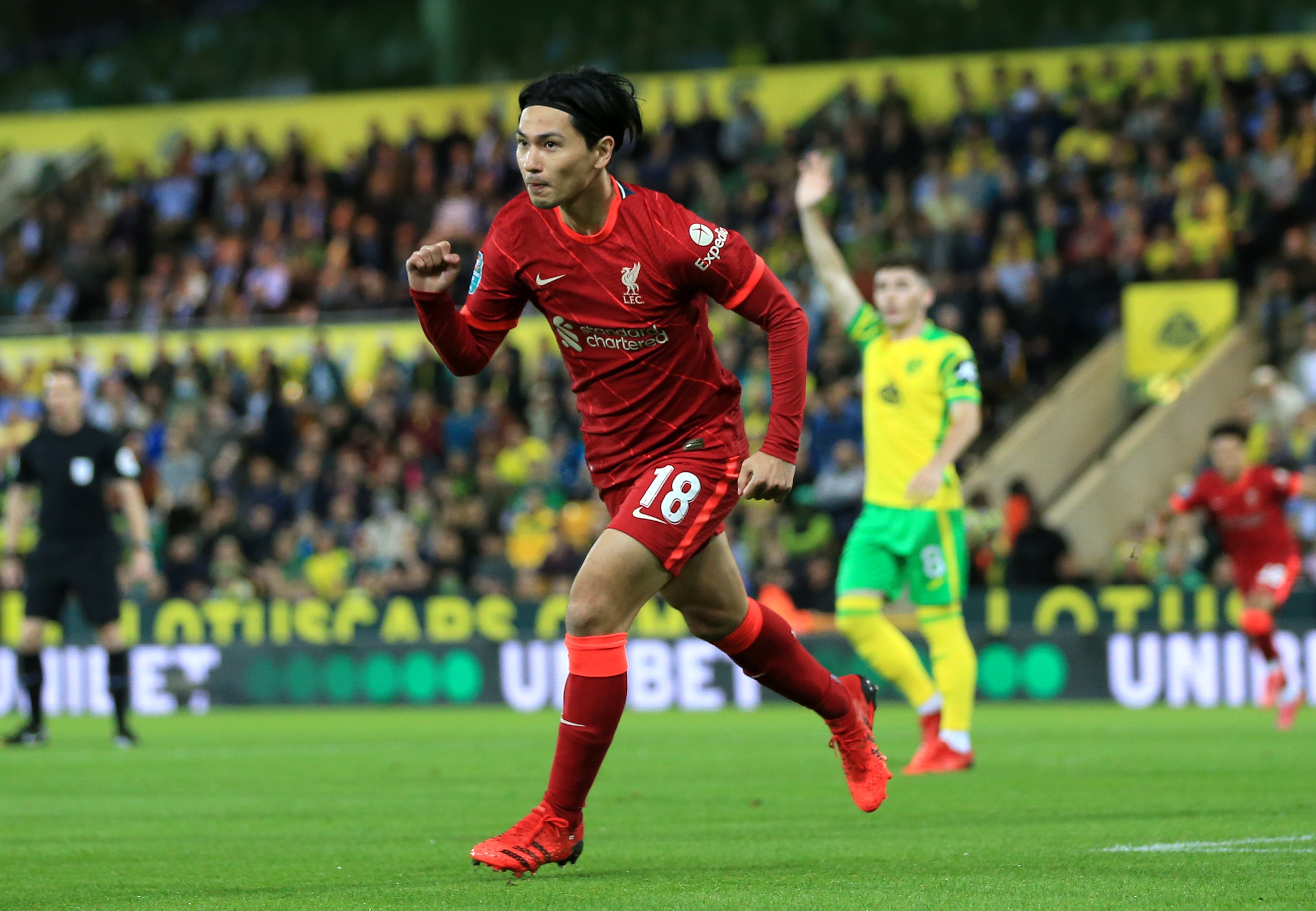 Takumi Minamino of Liverpool celebrates after scoring their sides first goal during the Carabao Cup Third Round match between Norwich City and Liverpool at Carrow Road on September 21, 2021 in Norwich, England