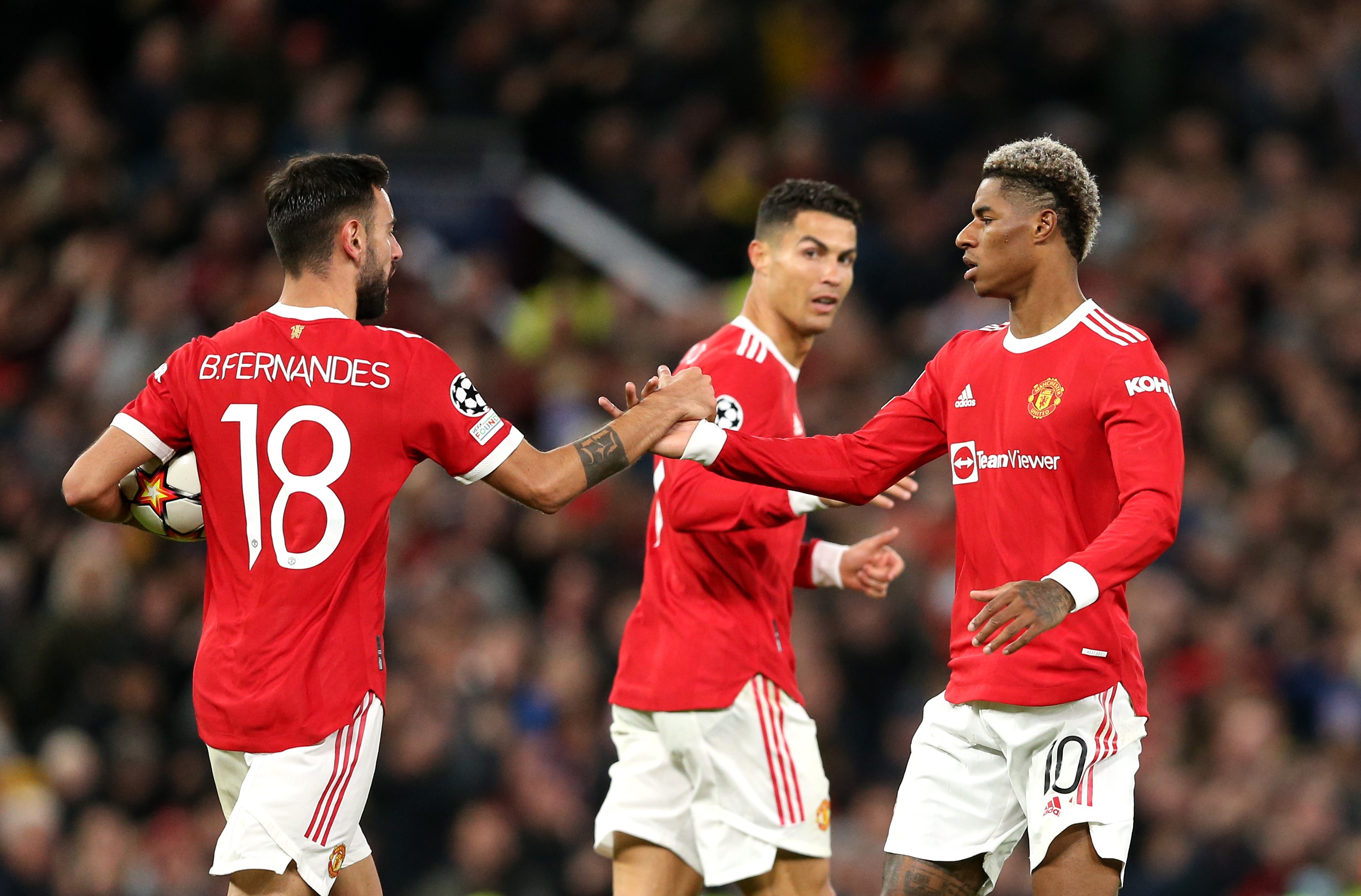 MANCHESTER, ENGLAND - OCTOBER 20: Marcus Rashford of Manchester United celebrates with teammate Bruno Fernandes scores their side's first goal during the UEFA Champions League group F match between Manchester United and Atalanta at Old Trafford on October