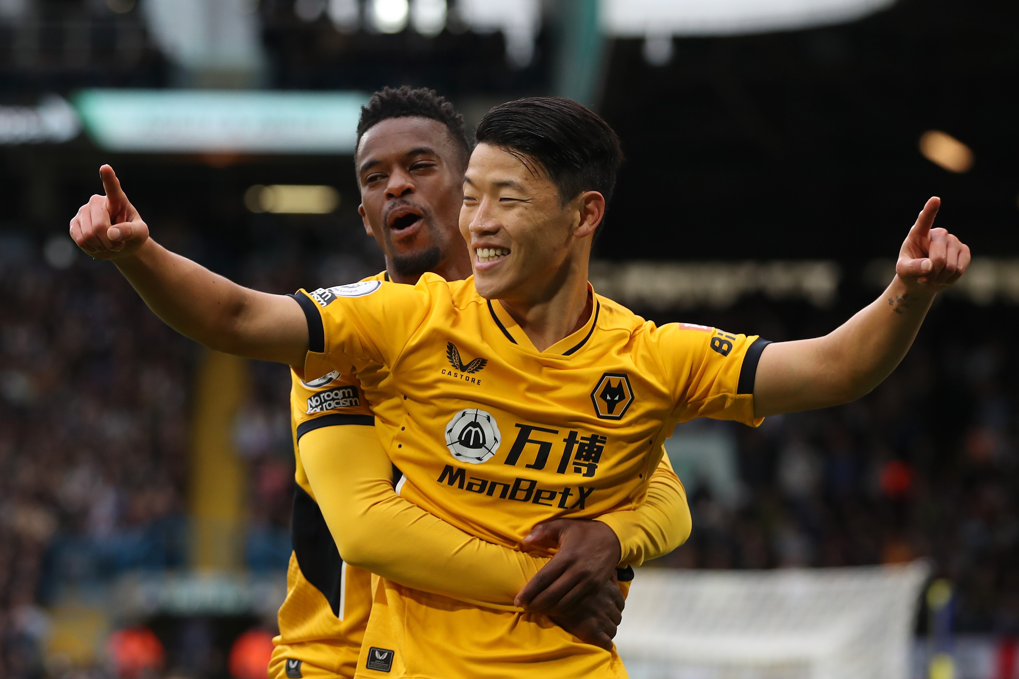 Hwang Hee-chan of Wolverhampton Wanderers celebrates with teammate Nelson Semedo after scoring their side's first goal during the Premier League match between Leeds United and Wolverhampton Wanderers at Elland Road on October 23, 2021 in Leeds, England