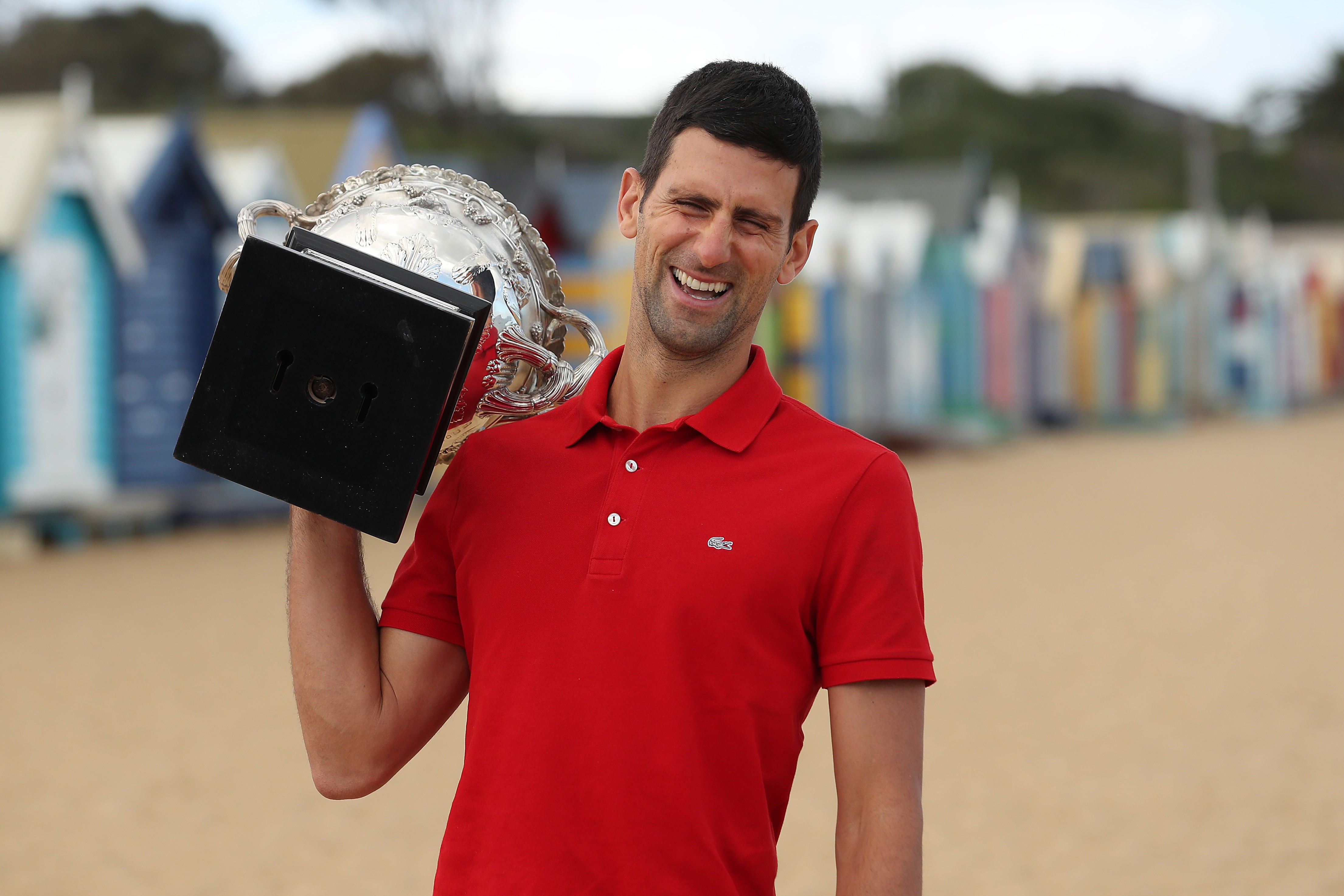 Novak Djokovic of Serbia poses with the Norman Brookes Challenge Cup after winning the 2021 Australian Open Men's Final, at Brighton Beach on February 22, 2021 in Melbourne, Australia.