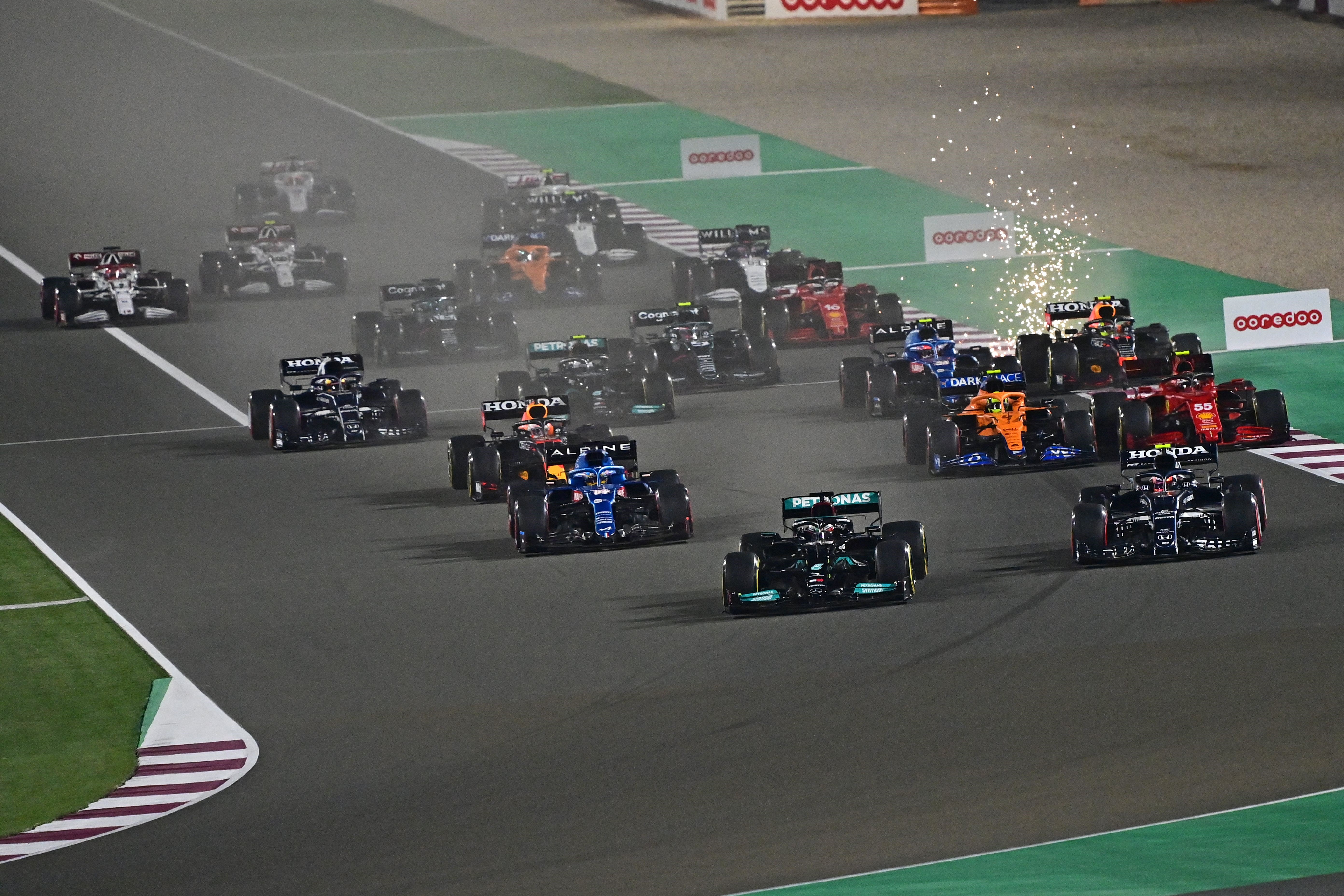 British driver Lewis Hamilton (front-C) leads the pack at the start of the Qatari Formula One Grand Prix at the Losail International Circuit, on the outskirts of the capital city of Doha, on November 21, 2021