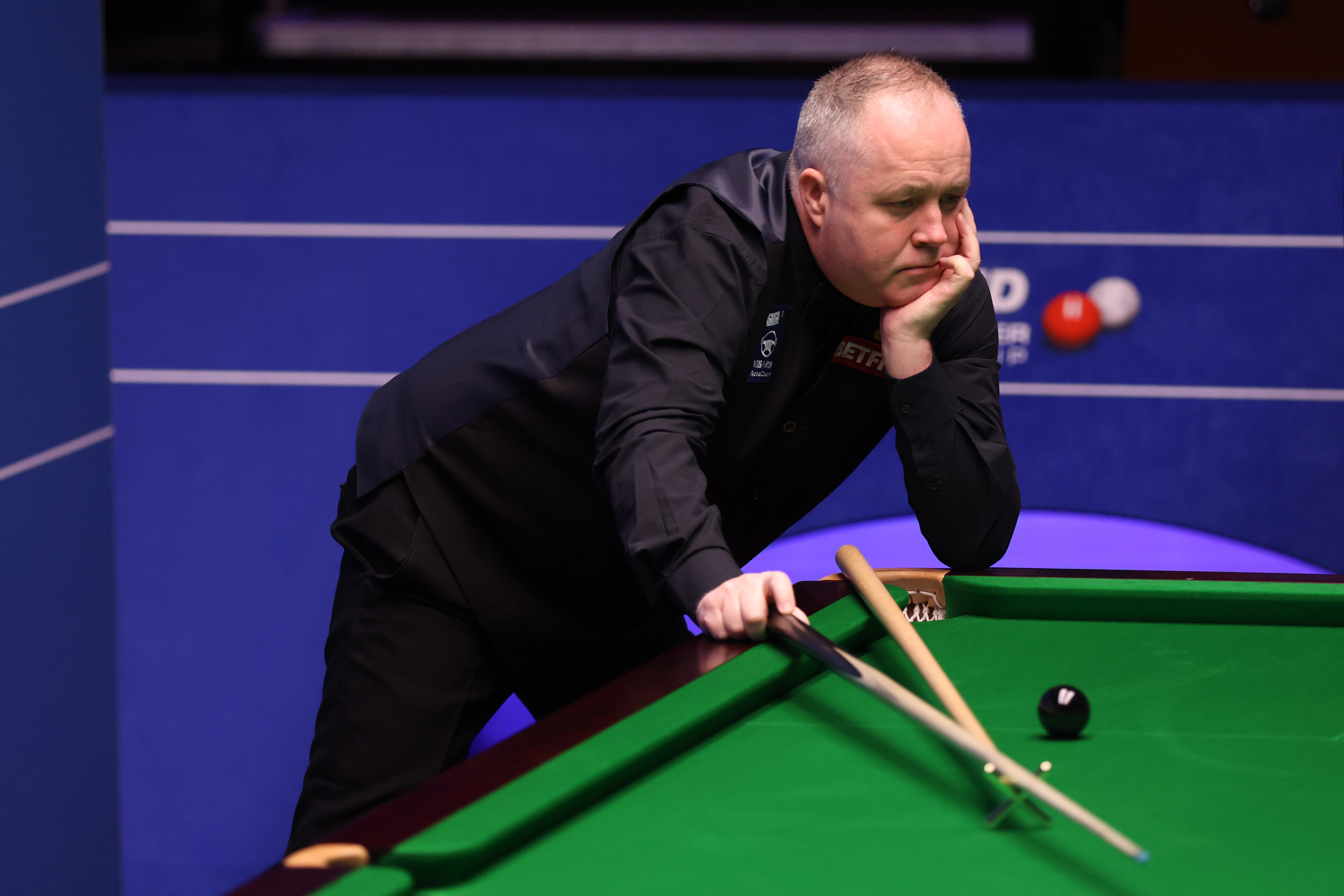 John Higgins looks pensive as he considers a shot