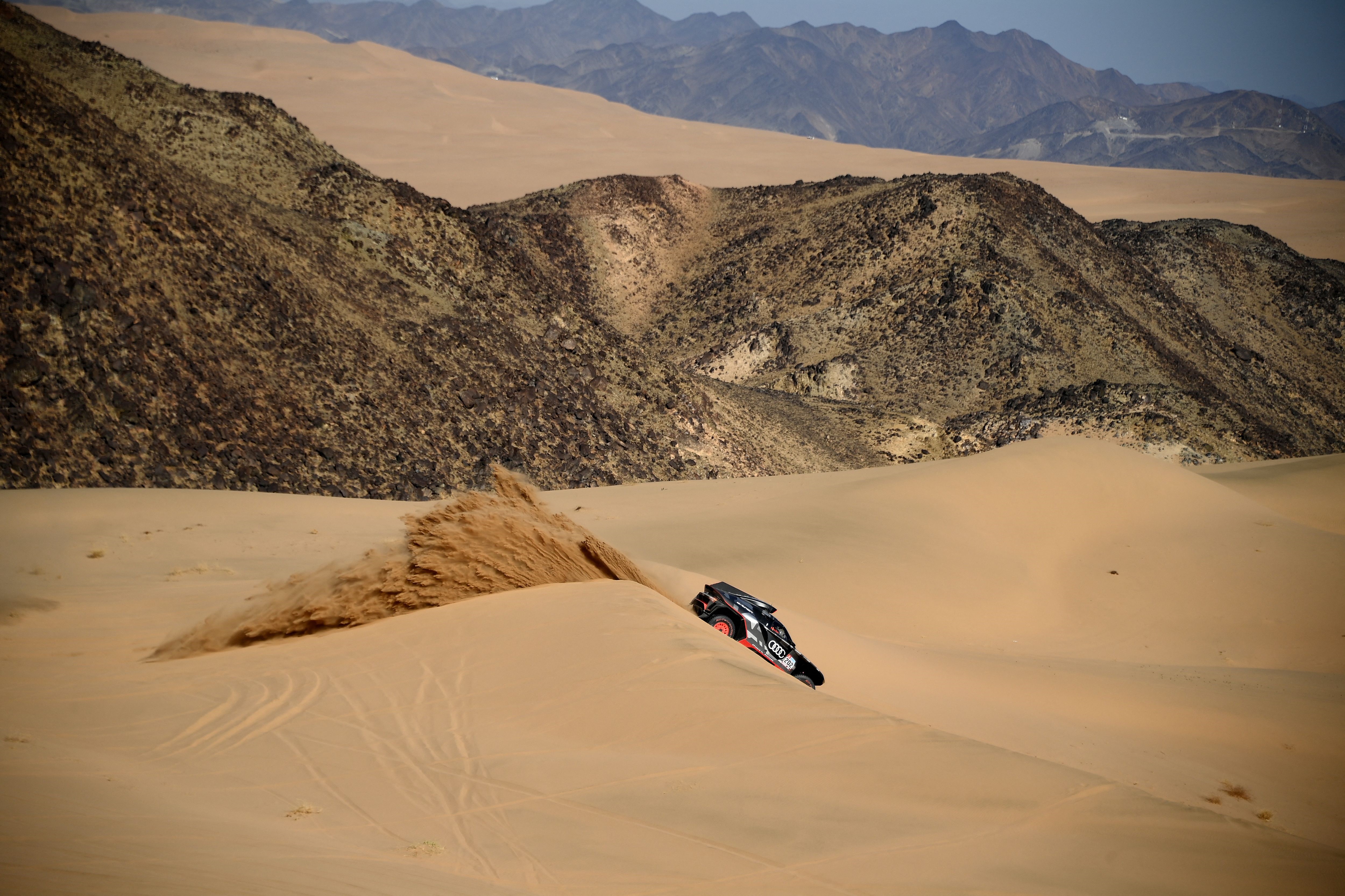 Audi's electric Spanish driver Carlos Sainz of Spain and co-driver Lucas Cruz of Spain compete during Stage 1A of the Dakar 2022 rally between the Saudi cities of Jeddah and Hail, on January 1, 2022