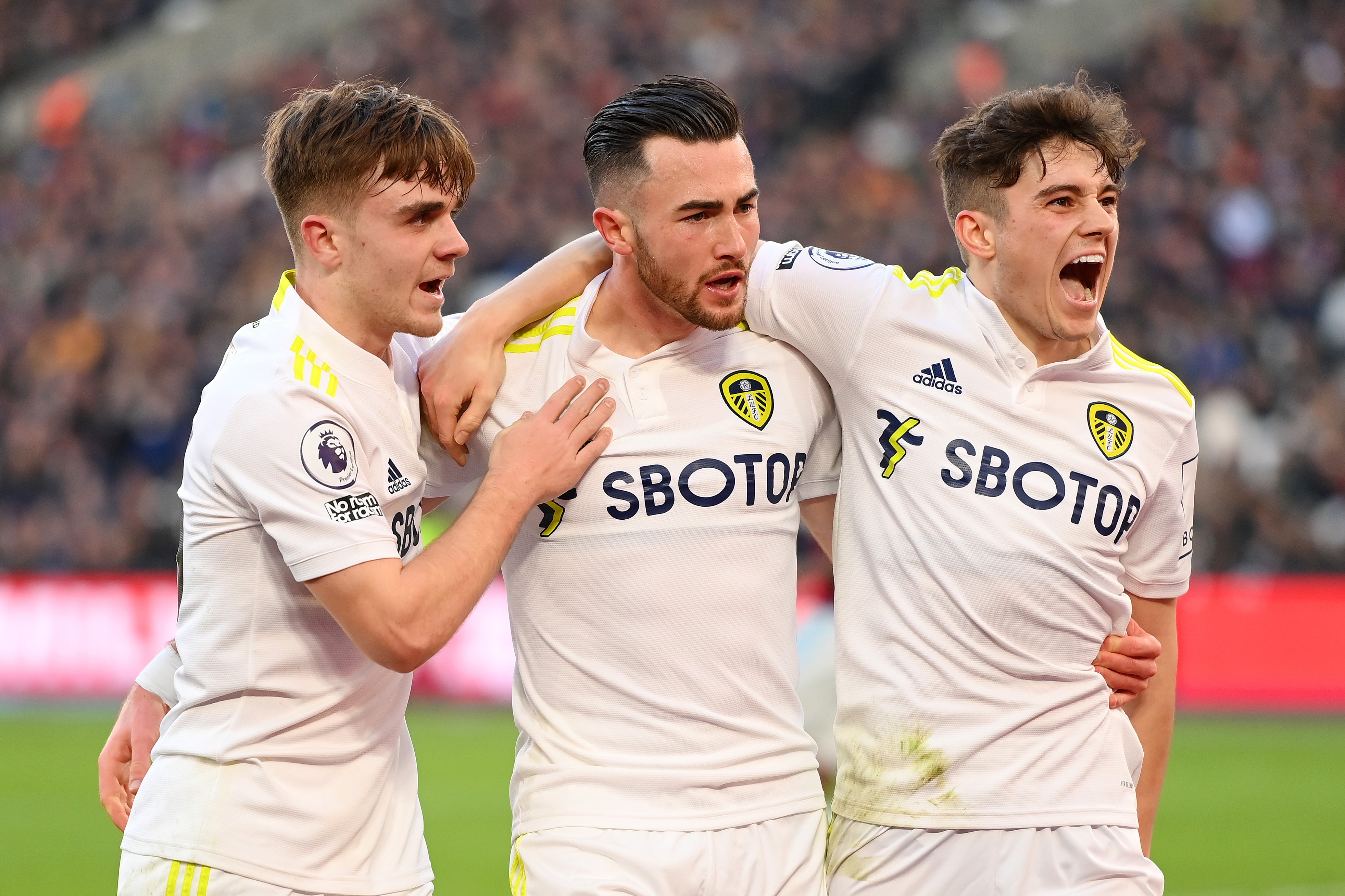 Jack Harrison celebrates with Lewis Bate and Daniel James of Leeds Unitedafter scoring their team's third goal during the Premier League match between West Ham United and Leeds United at London Stadium on January 16, 2022 in London, England.