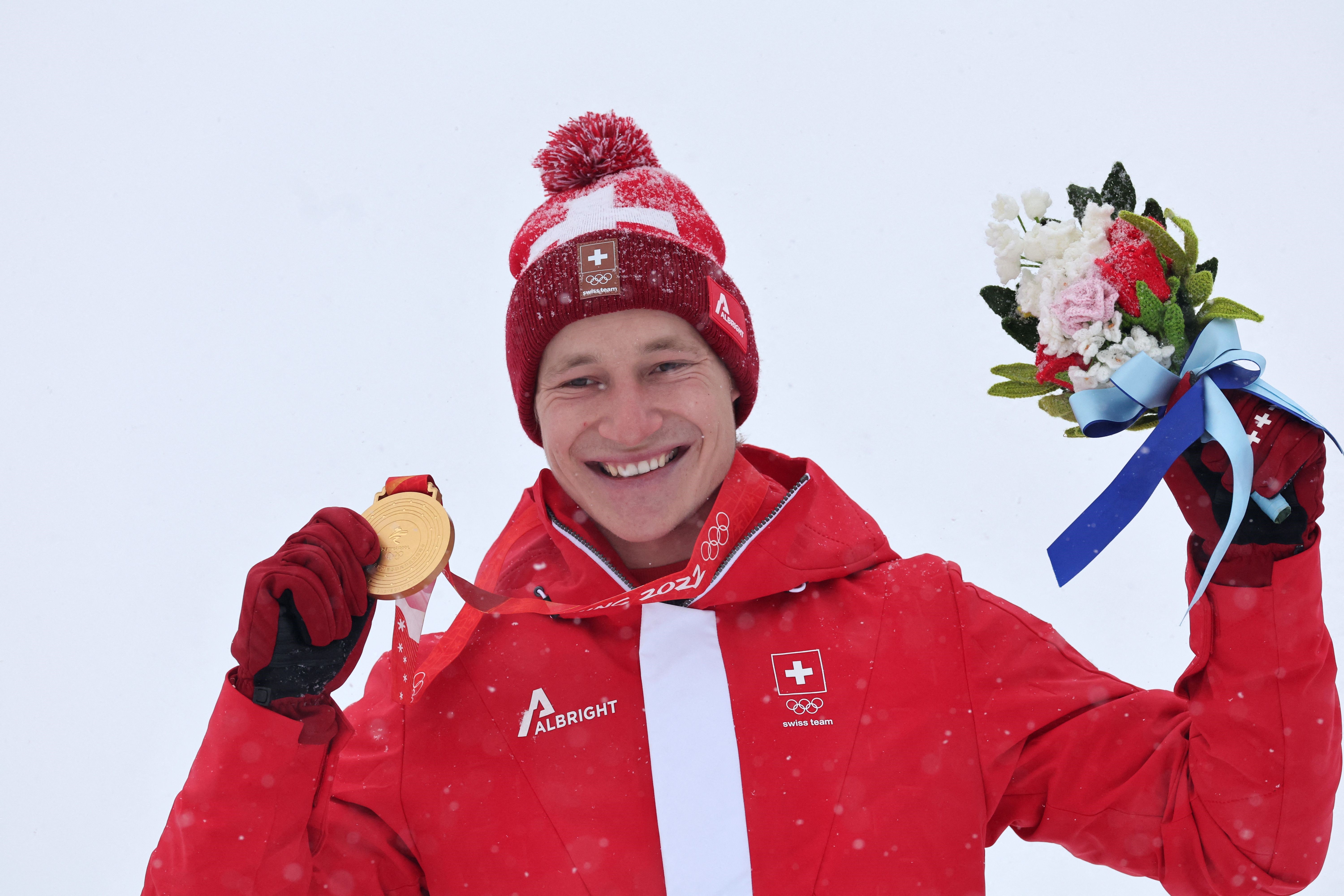 Gold medallist Switzerland's Marco Odermatt poses on the podium during the men's giant slalom victory ceremony of the Beijing 2022 Winter Olympic Games