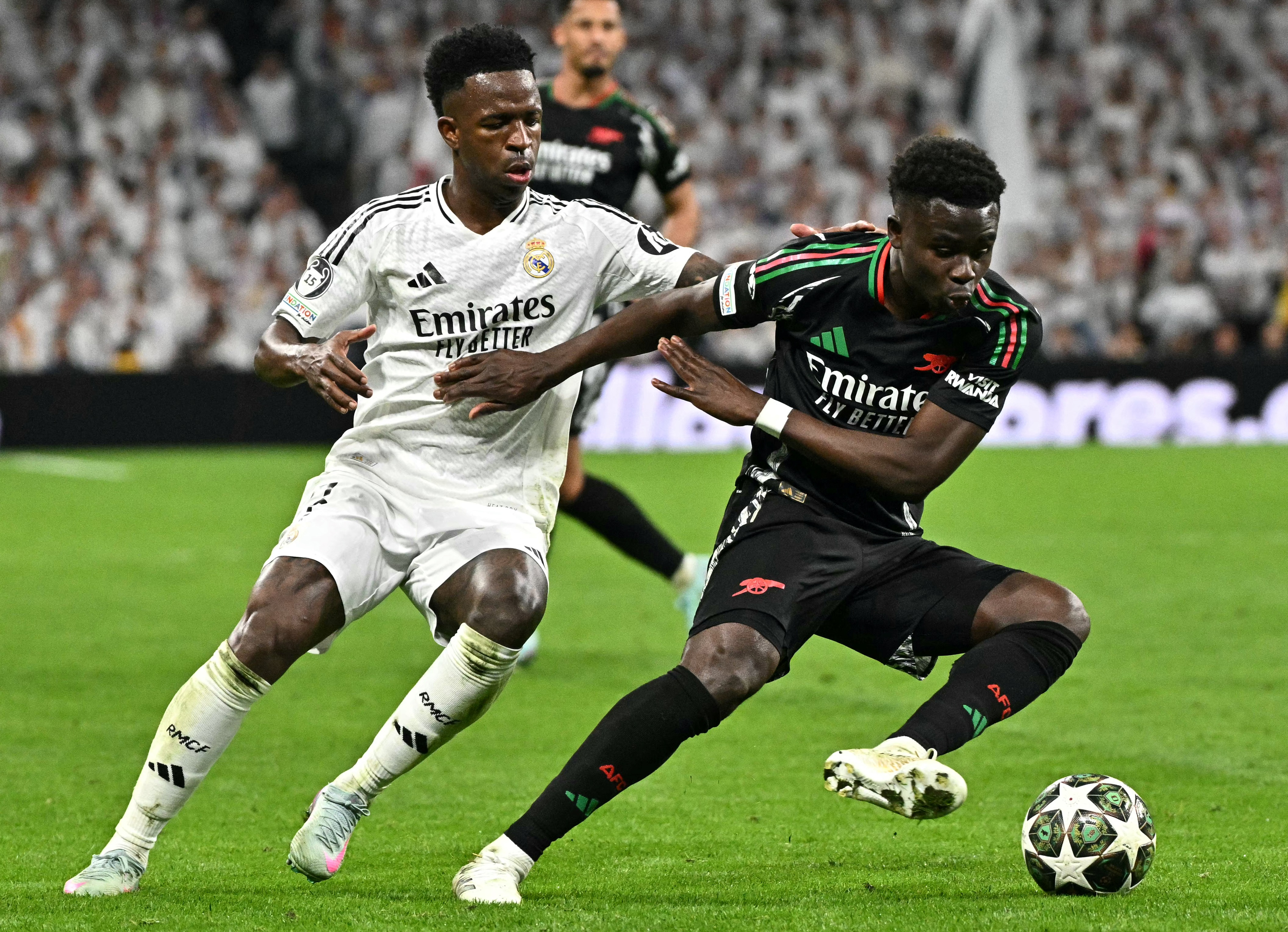 Saka clashing with Vinicius in the UEFA Champions League last season.