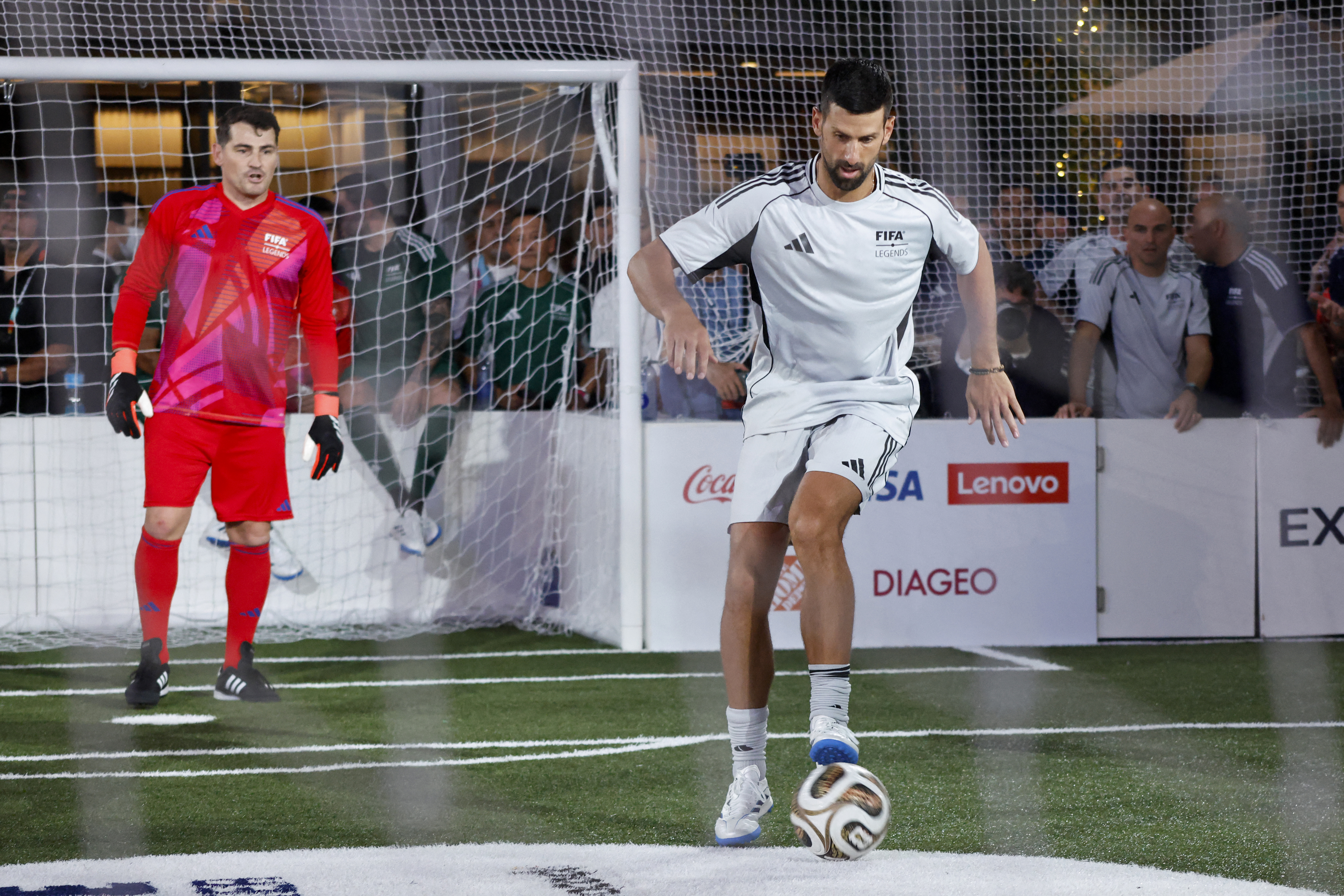 Serbian tennis player Novak Djokovic (R) controls the ball next to former Spanish goalkeeper Iker Casillas during the Legends Cup of the 2026 World Cup football tournament at the Rockefeller Center in New York on July 17, 2026.