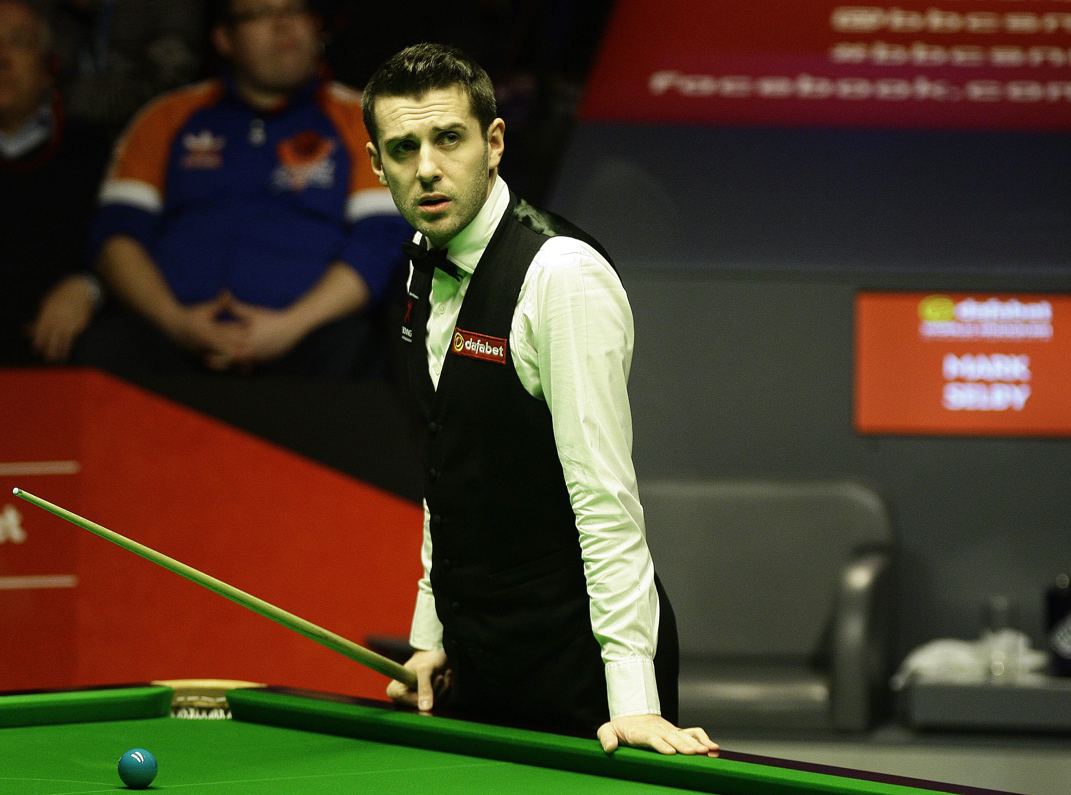 Mark Selby studies a scoreboard at the Crucible.