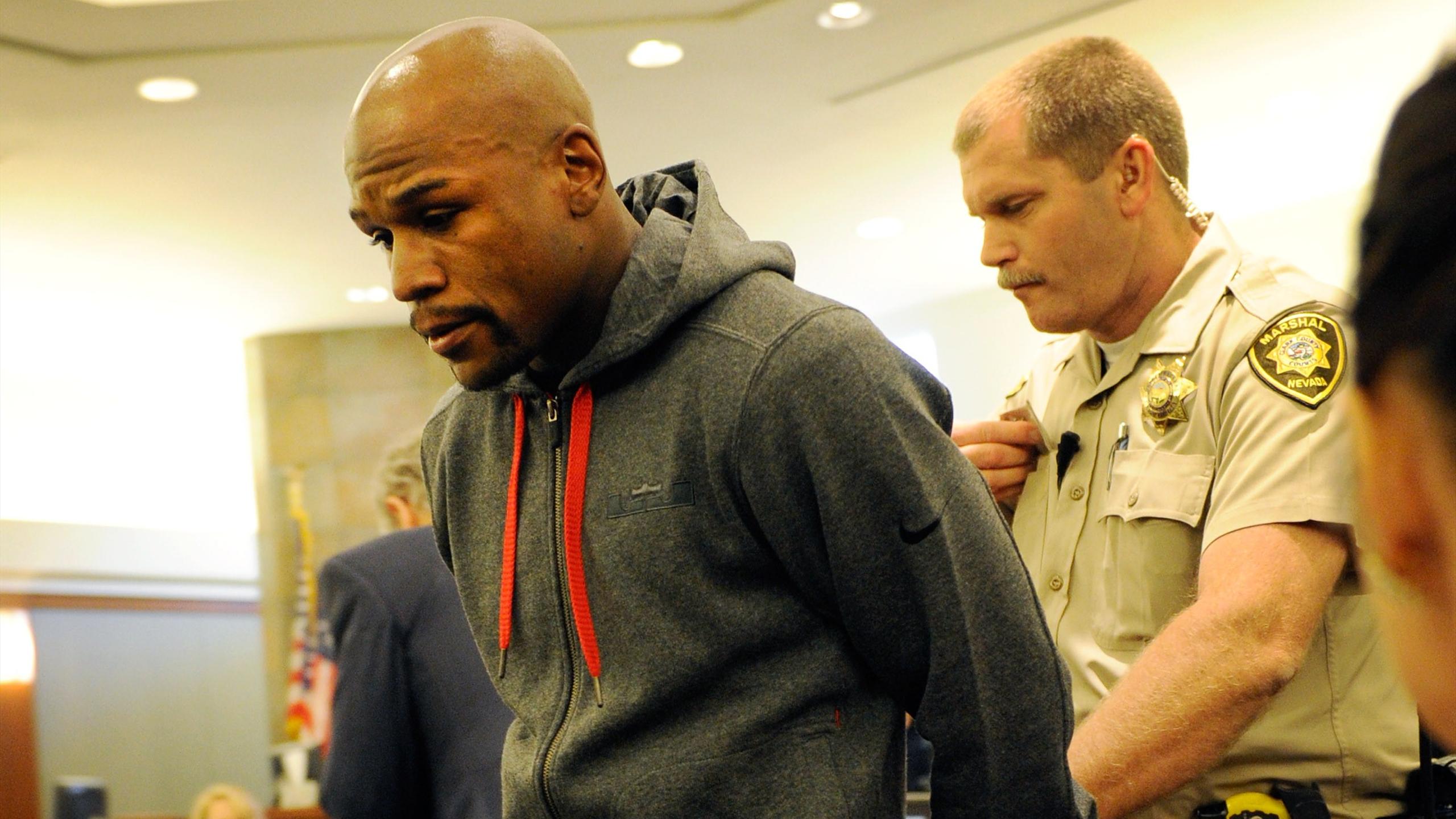 Boxer Floyd Maywether Jr. is lead away in handcuffs at the Clark County Regional Justice Center as he surrenders to serve a three-month jail sentence on June 1, 2012 in Las Vegas, Nevada