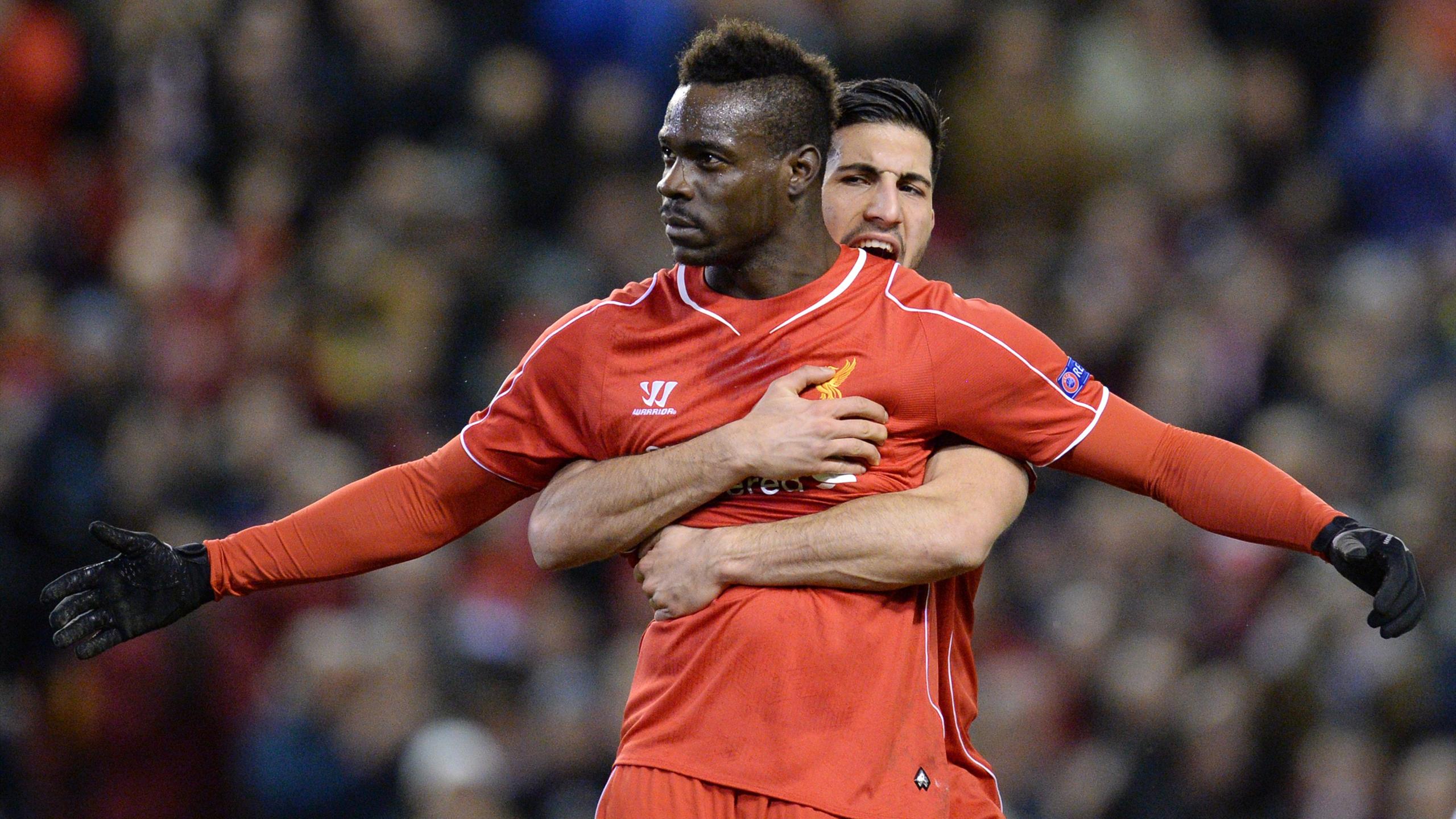 Liverpool's Italian striker Mario Balotelli (C) spreads his arms wide after scoring the opening goal from the penalty spot during the UEFA Europa League round of 32 first leg football match between Liverpool and Besiktas at Anfield (AFP)